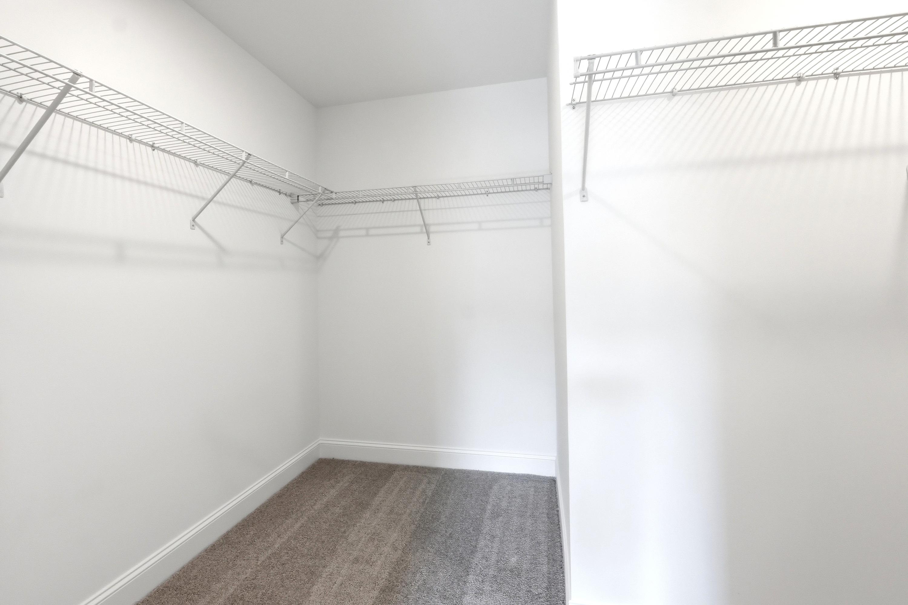 Spacious walk-in closet with wire shelving in the master suite of The Russell A by Davidson Homes.