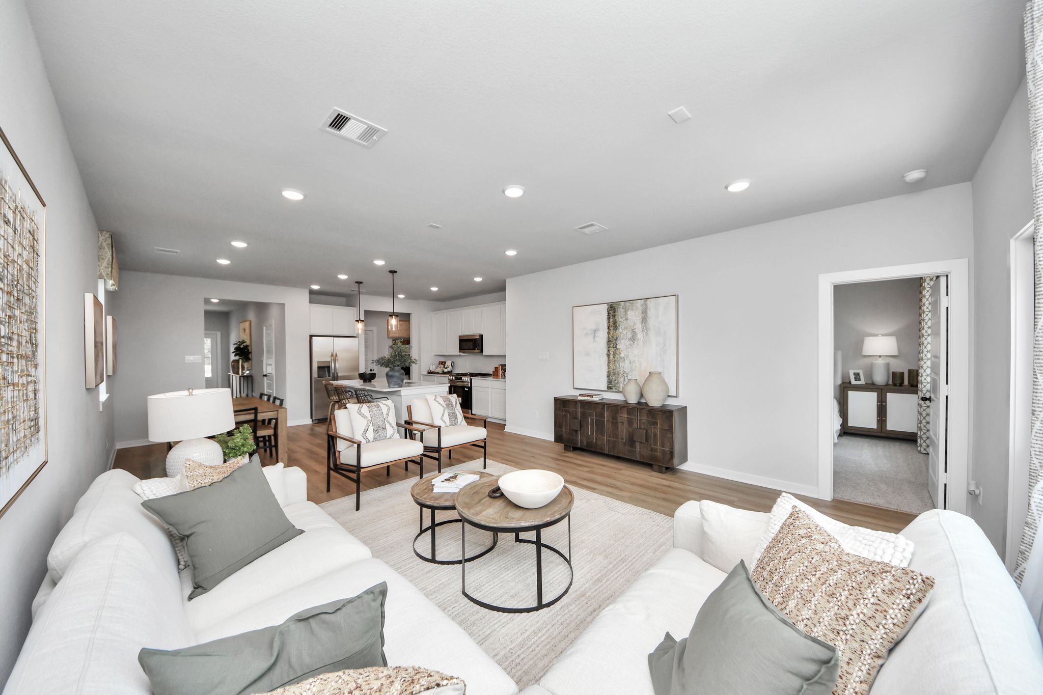 Open-concept living room at Robins Landing in Houston, TX by Davidson Homes featuring modern decor and hardwood floors.