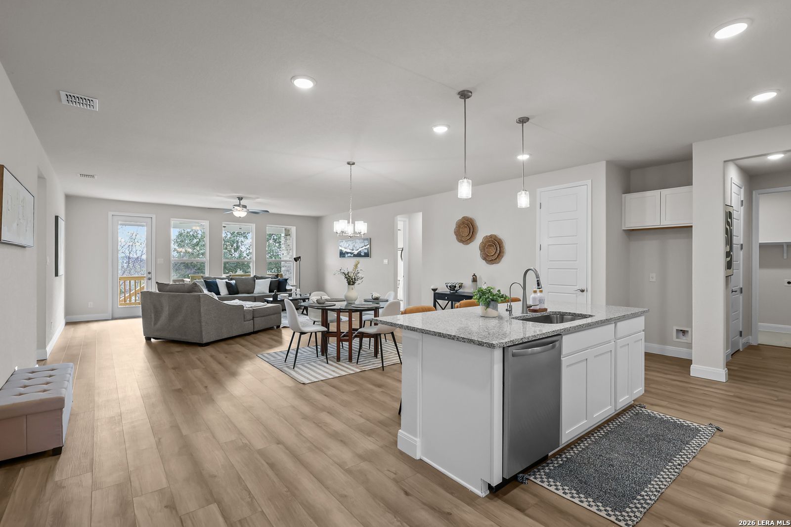 Open-concept kitchen and living area in The Lanier H floor plan by Davidson Homes in Ladera, San Antonio, Texas.