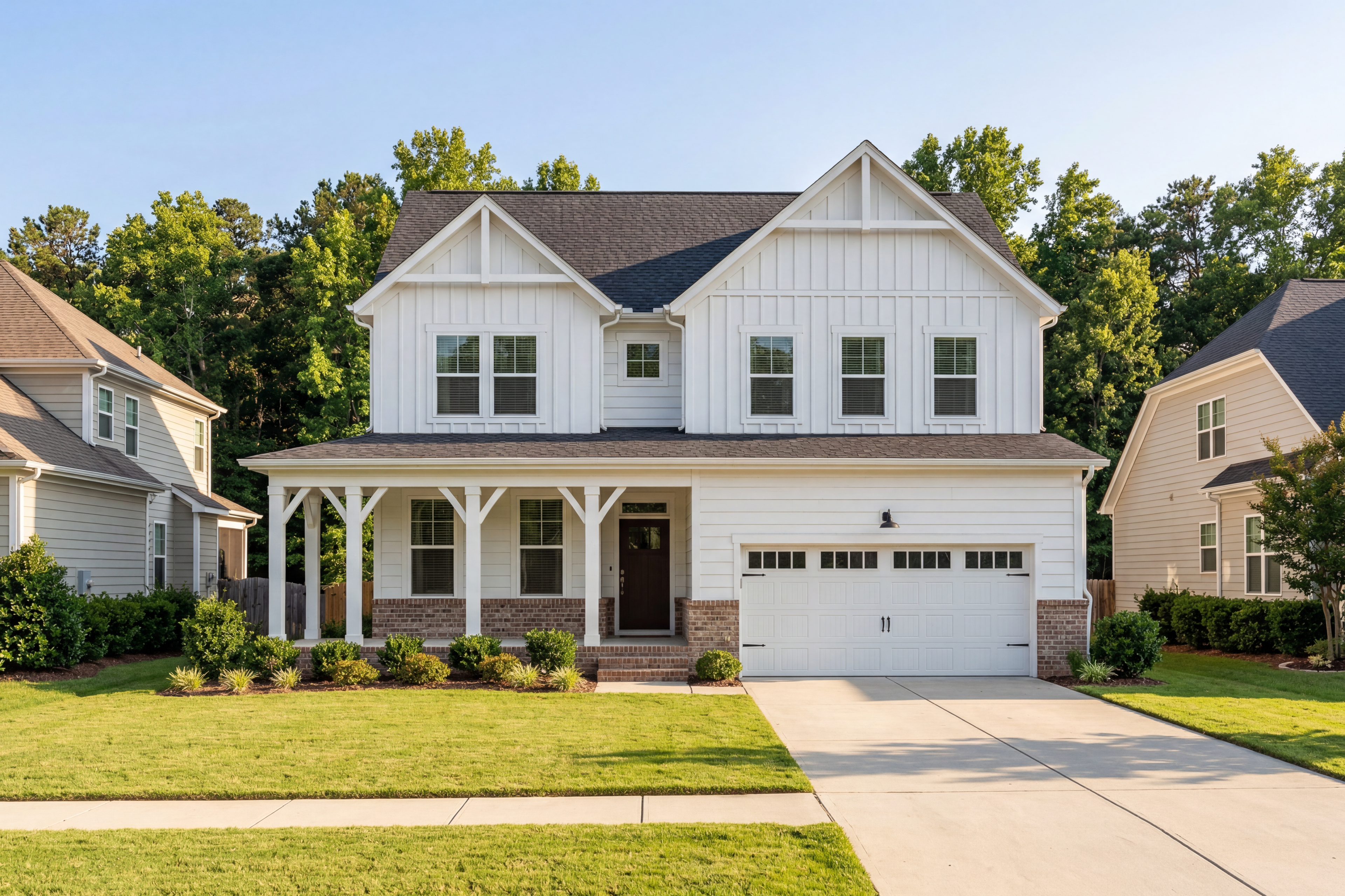 Modern farmhouse-style The Willow E home by Davidson Homes in Angier NC: two-story white siding, wrap-around porch, two-car garage
