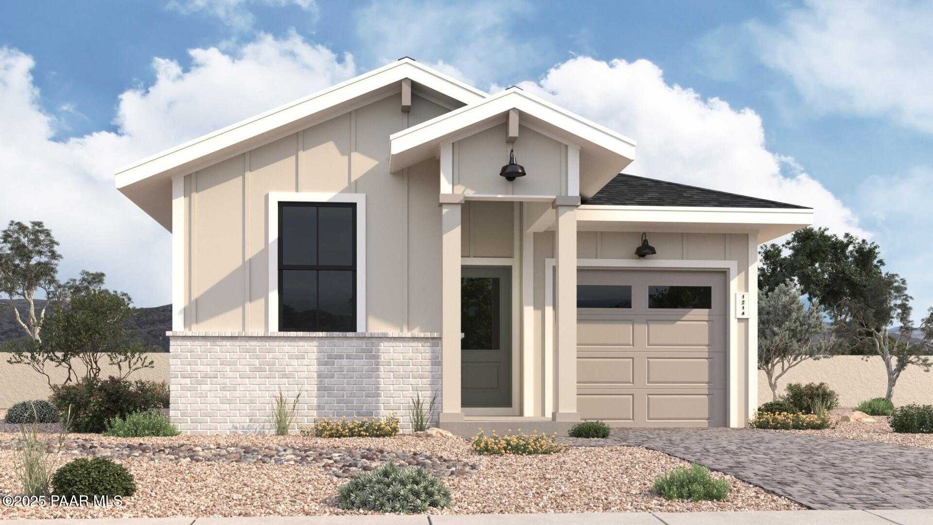 Charming beige single-story home with 2-car garage, gabled roof, and desert landscaping in South Ranch, Prescott, Arizona