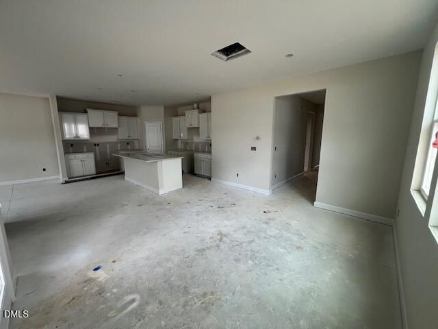 Open-concept kitchen with white shaker cabinets, island, and sink in The Preston A 4-bedroom home, Lillington, NC