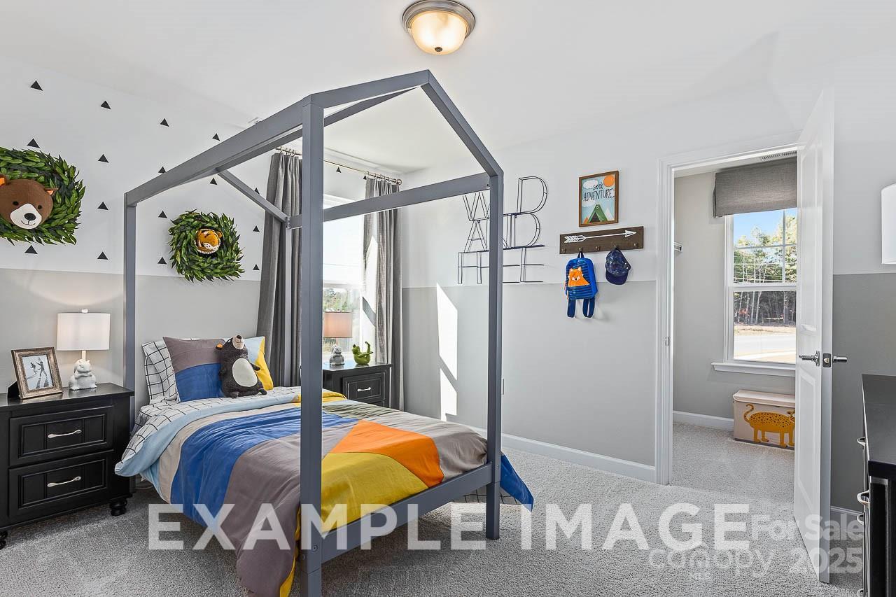 Charming kids' bedroom with house-frame loft bed, bear motifs, and play desk in Davidson Homes The Hemlock A, Enclave at Belmont, NC