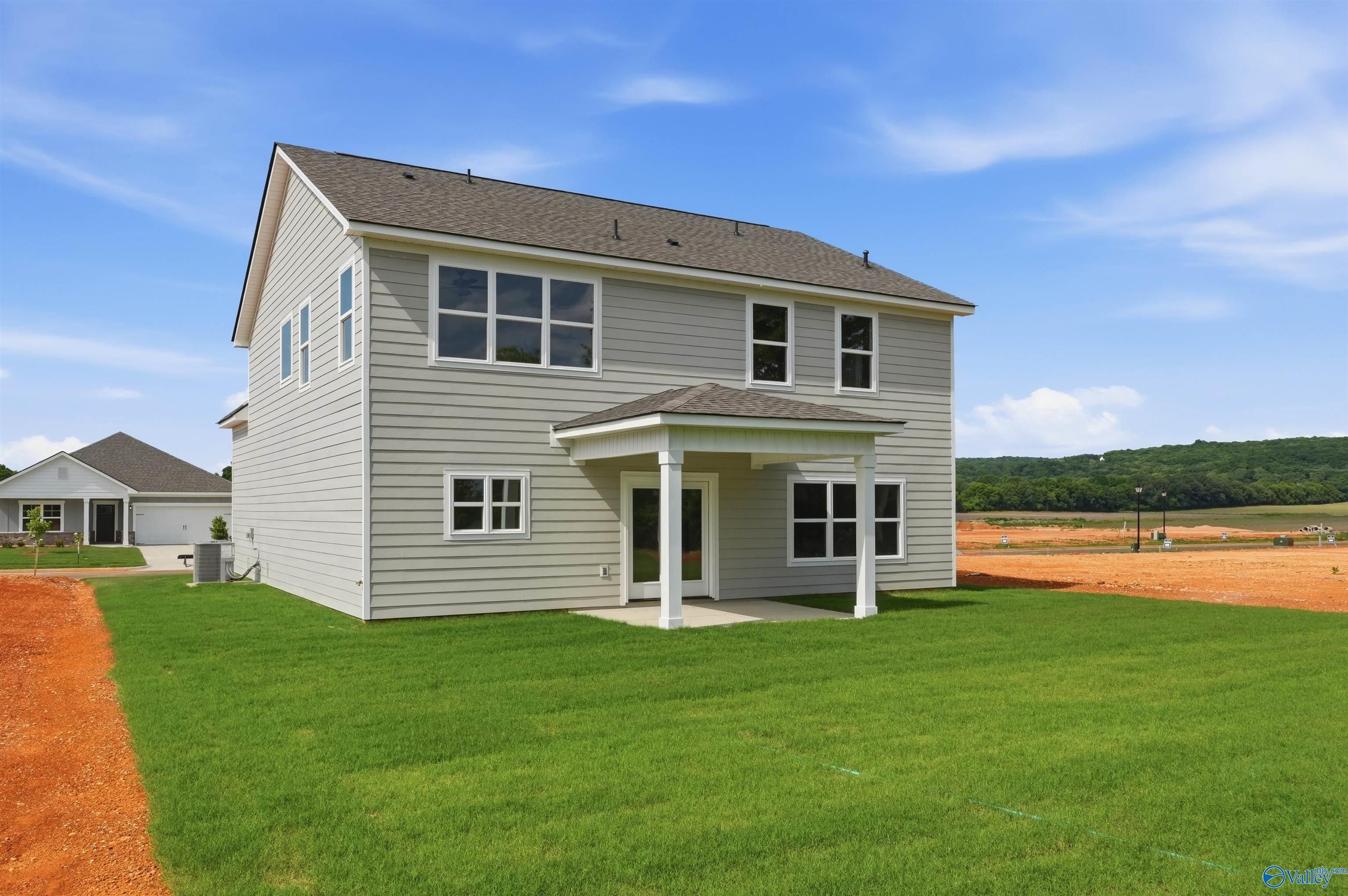 Rear view of 2-story The Chelsea D floor plan by Davidson Homes with covered patio in Berry Cove, New Market, Alabama.