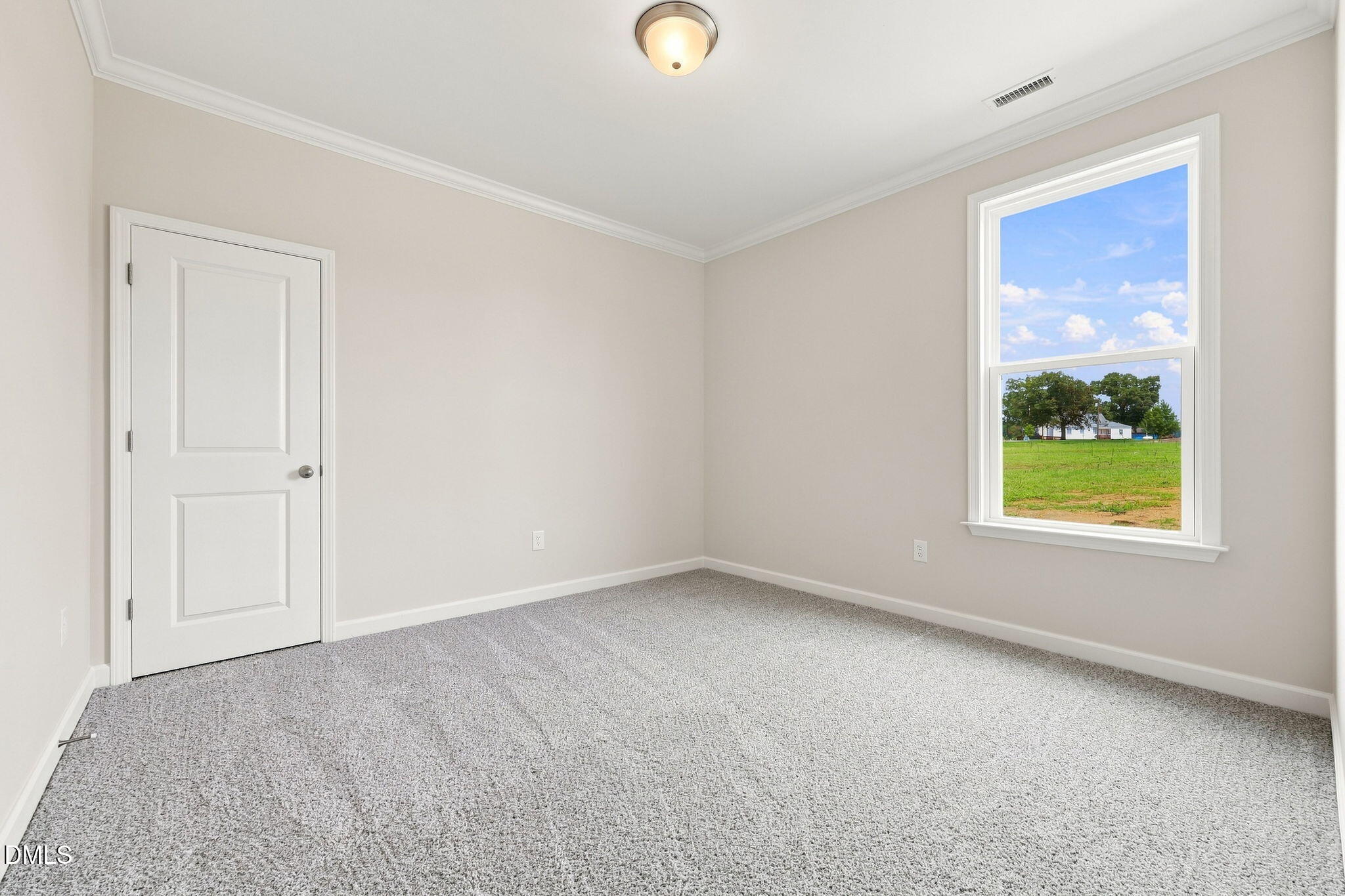 Bright, neutral secondary bedroom with plush carpeting in The Magnolia B floor plan at Retreat at North Main, Lillington.