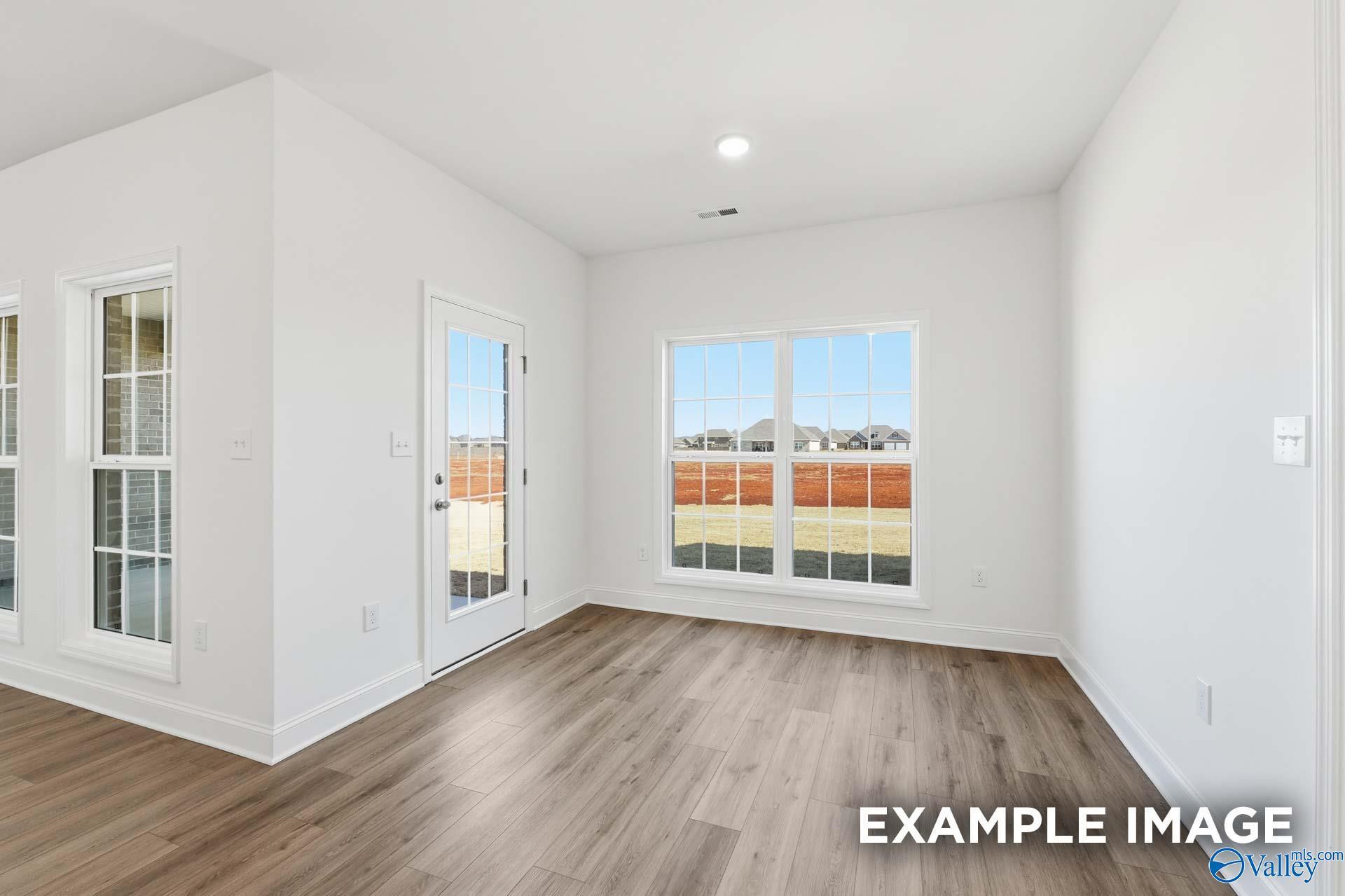 Bright, open-concept breakfast nook with wood-look flooring in The Valencia floor plan at Briercreek, Meridianville, AL.