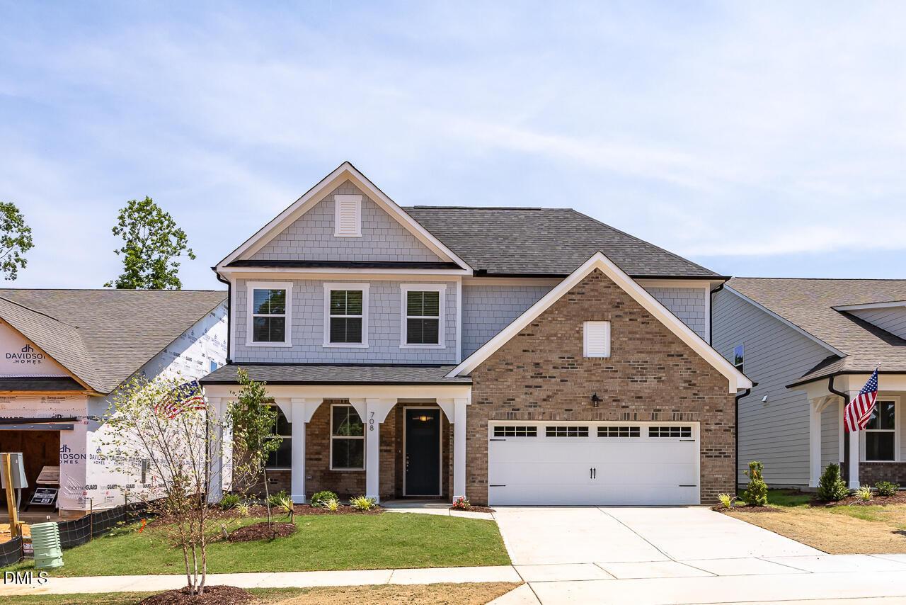 Two-story Ashport L floor plan by Davidson Homes with brick and siding exterior in Sage on North Main, Wake Forest, NC.