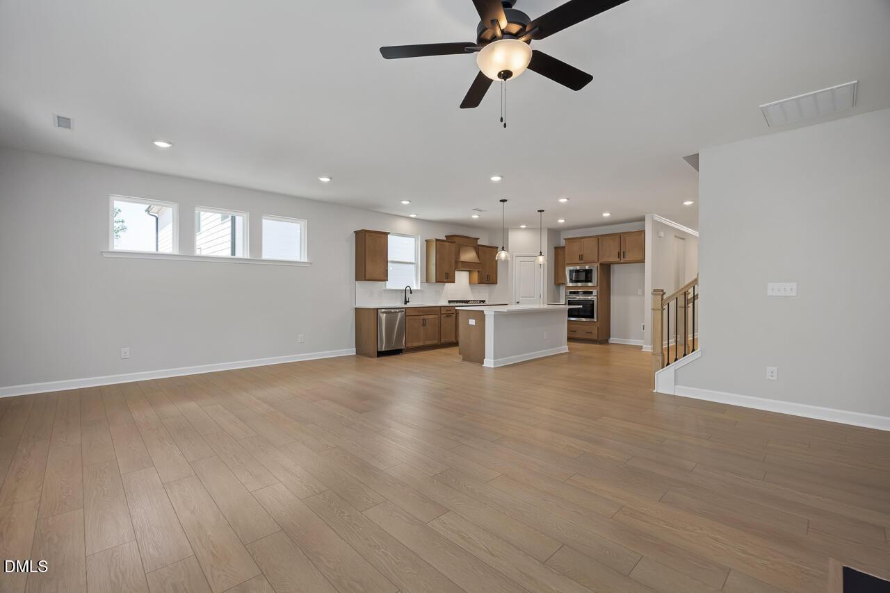 Open-concept kitchen and living area in The Ashport L floor plan at Sage on North Main in Wake Forest, North Carolina.
