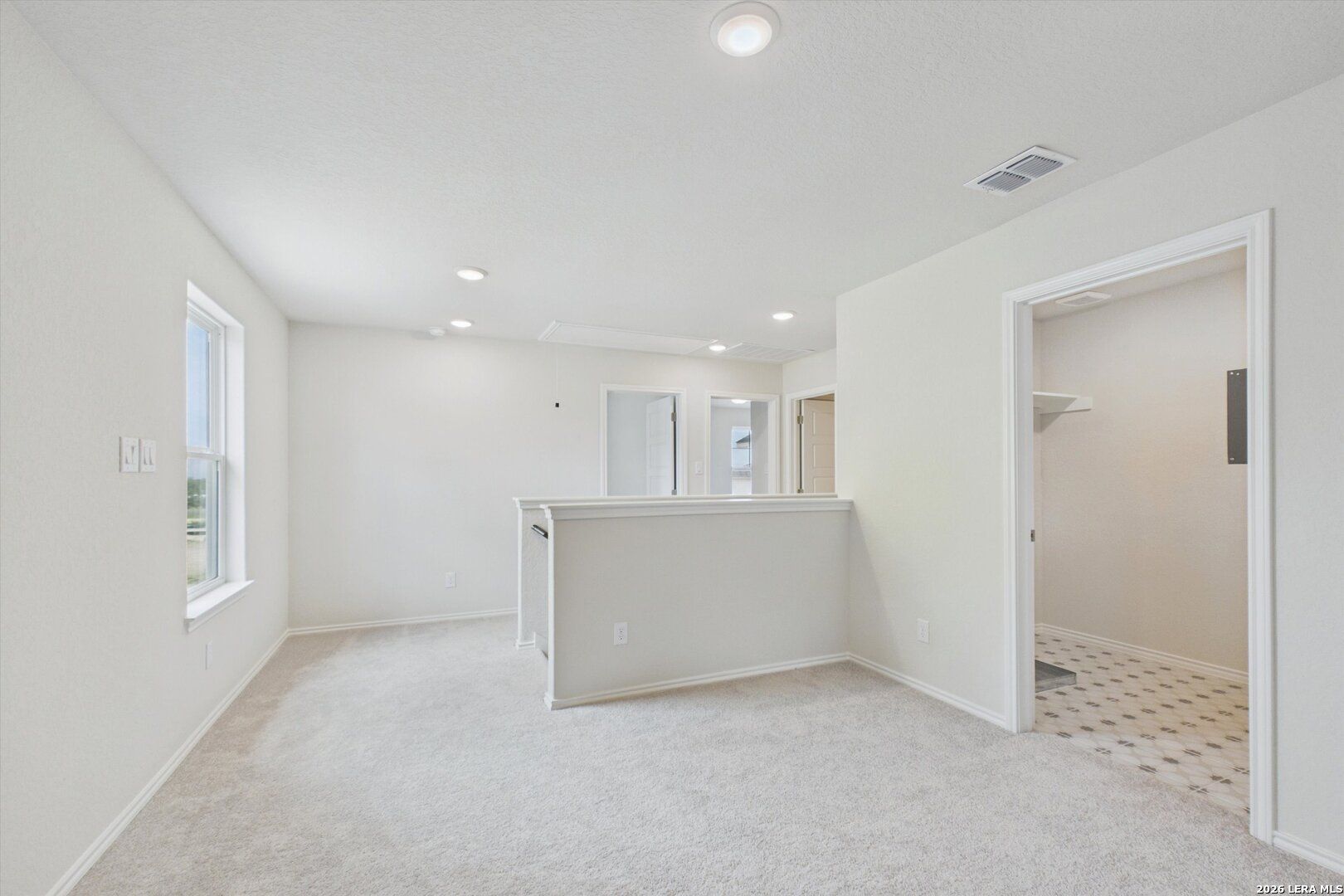 Spacious carpeted upstairs loft in The Charlotte B floor plan at Meadows at Oak Creek, San Antonio, Texas.