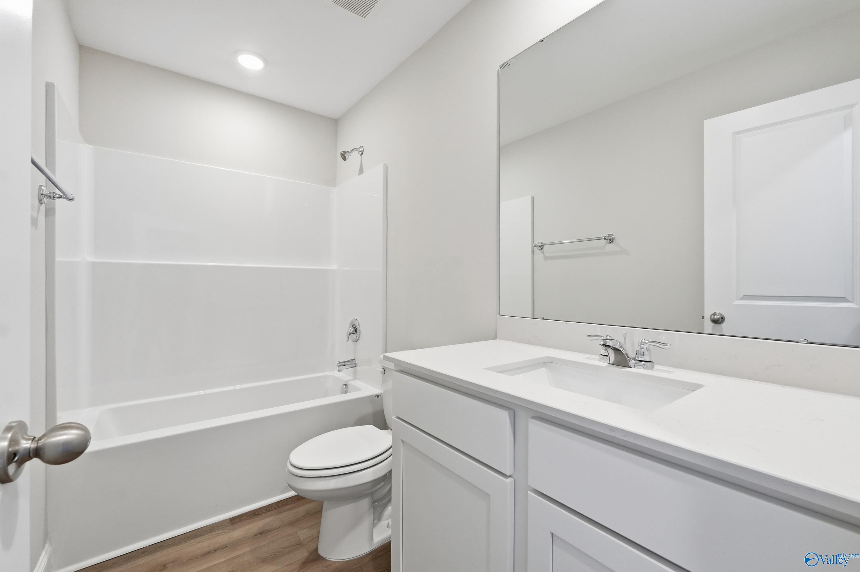 Modern master bathroom featuring double vanity, deep soaking tub, and tiled shower in Davidson Homes The Franklin, New Market, Alabama
