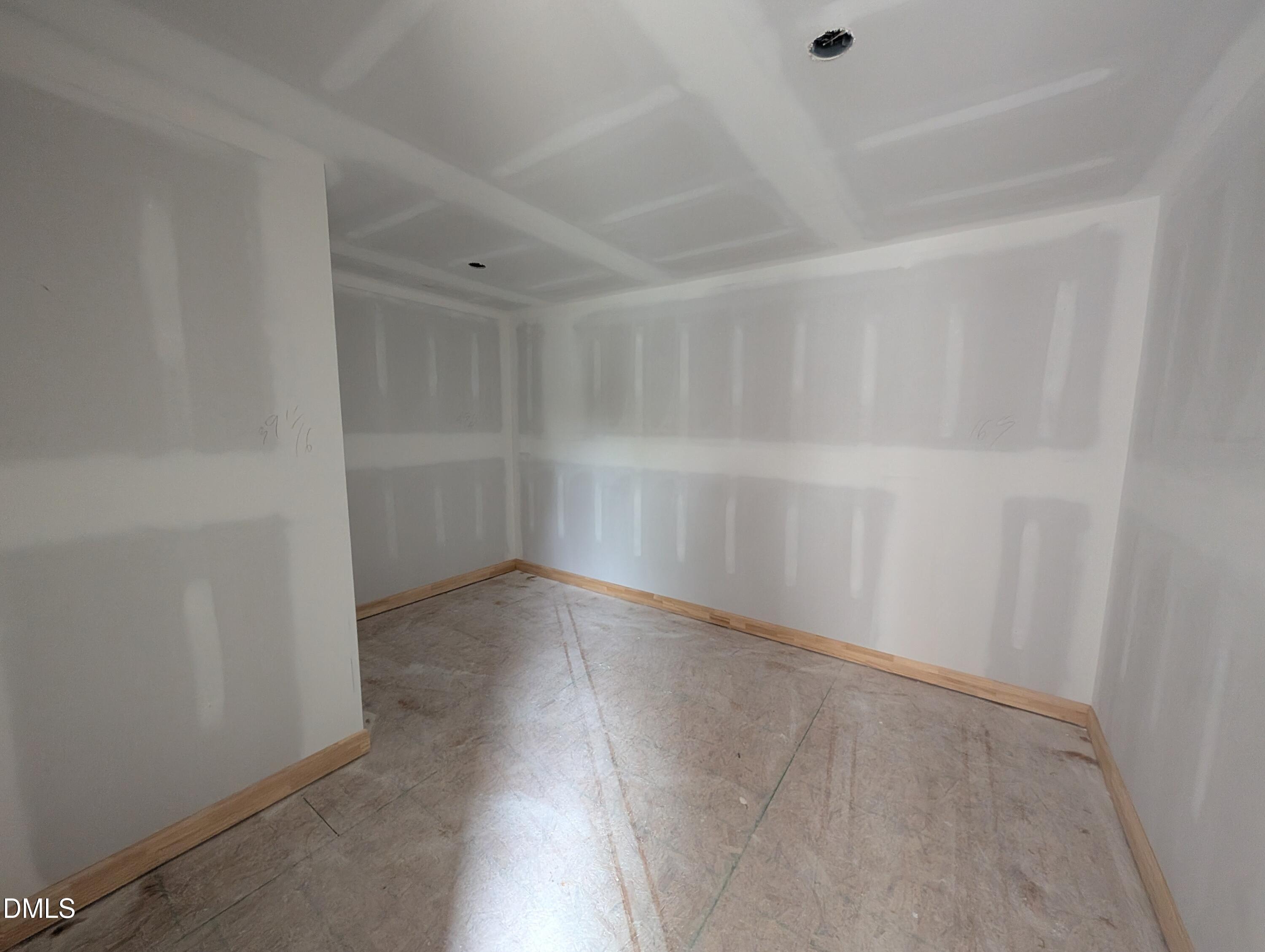 Unfinished bedroom with tray ceiling and wood trim in Davidson Homes The Beech floor plan, Wendell Ridge, North Carolina