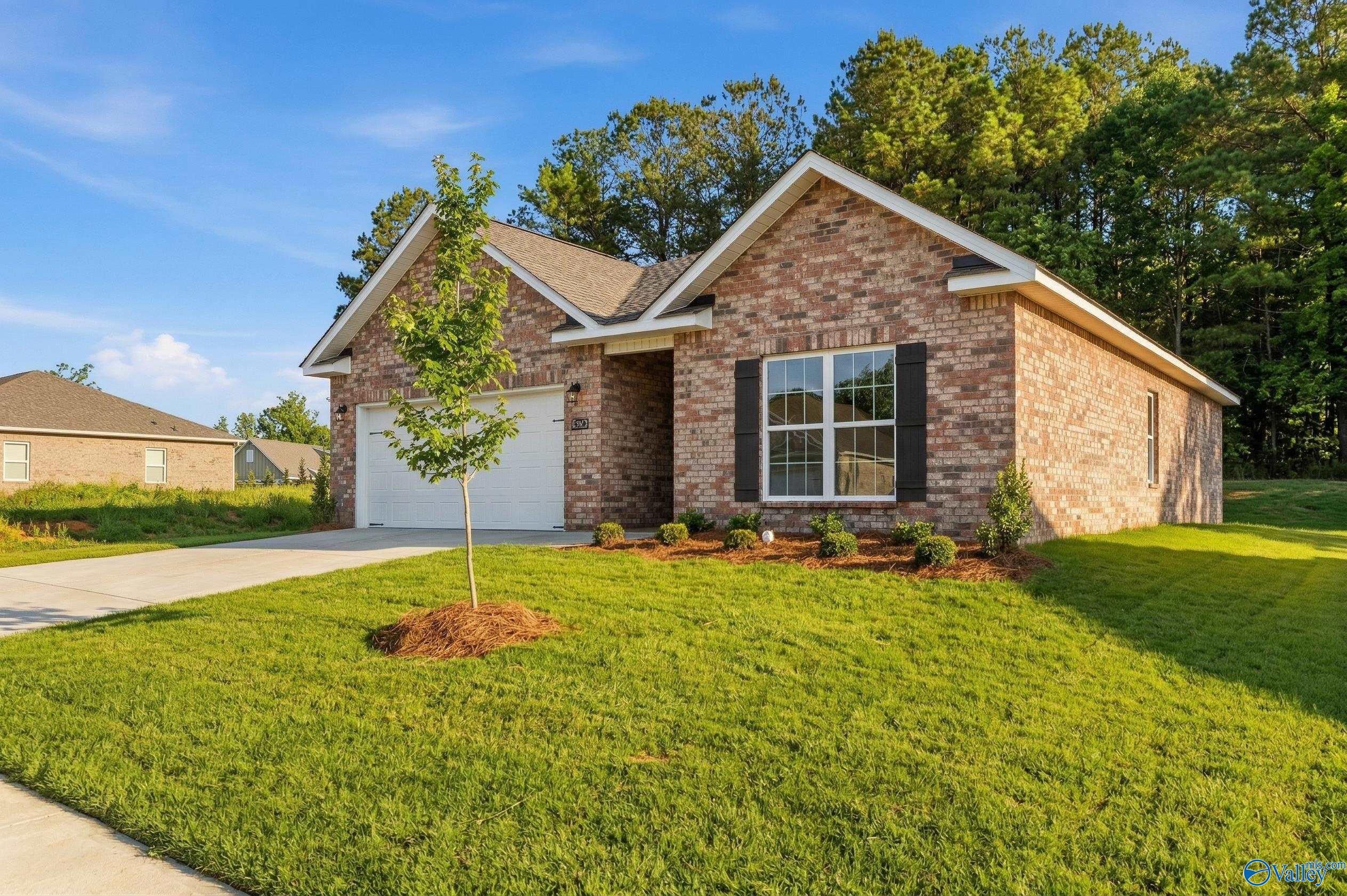 The Asheville C 1-story brick home with 2-car garage in The Highlands neighborhood of Arab, Alabama.