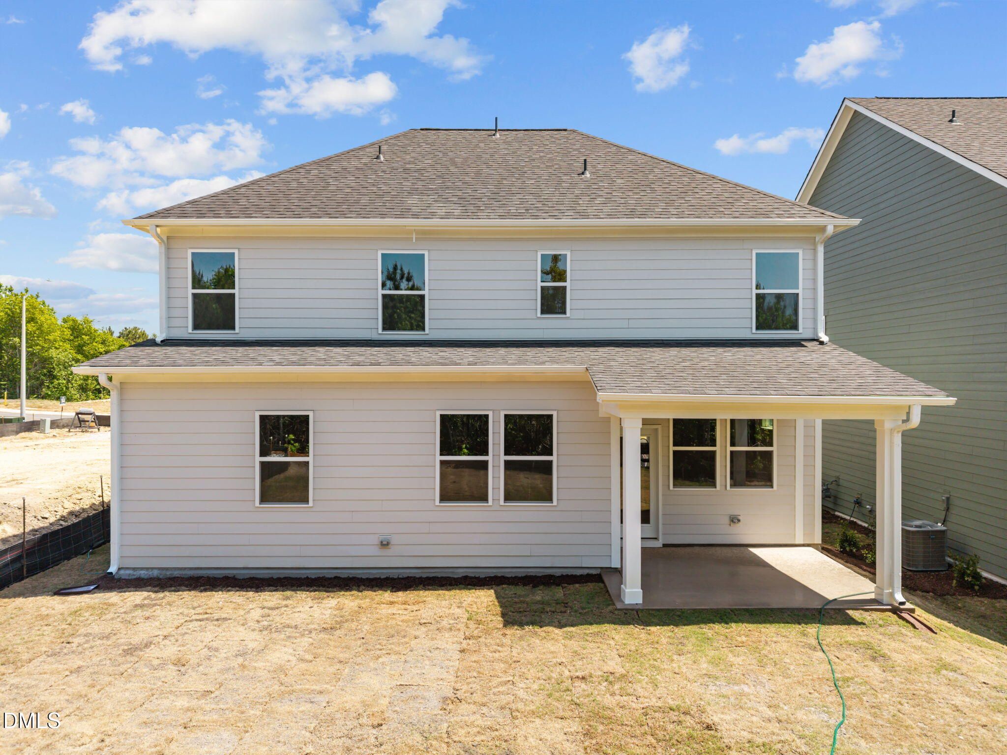 Rear view of two-story 4-bedroom Davidson Homes Willow D with covered porch, windows, and sod yard in Wendell Ridge, NC