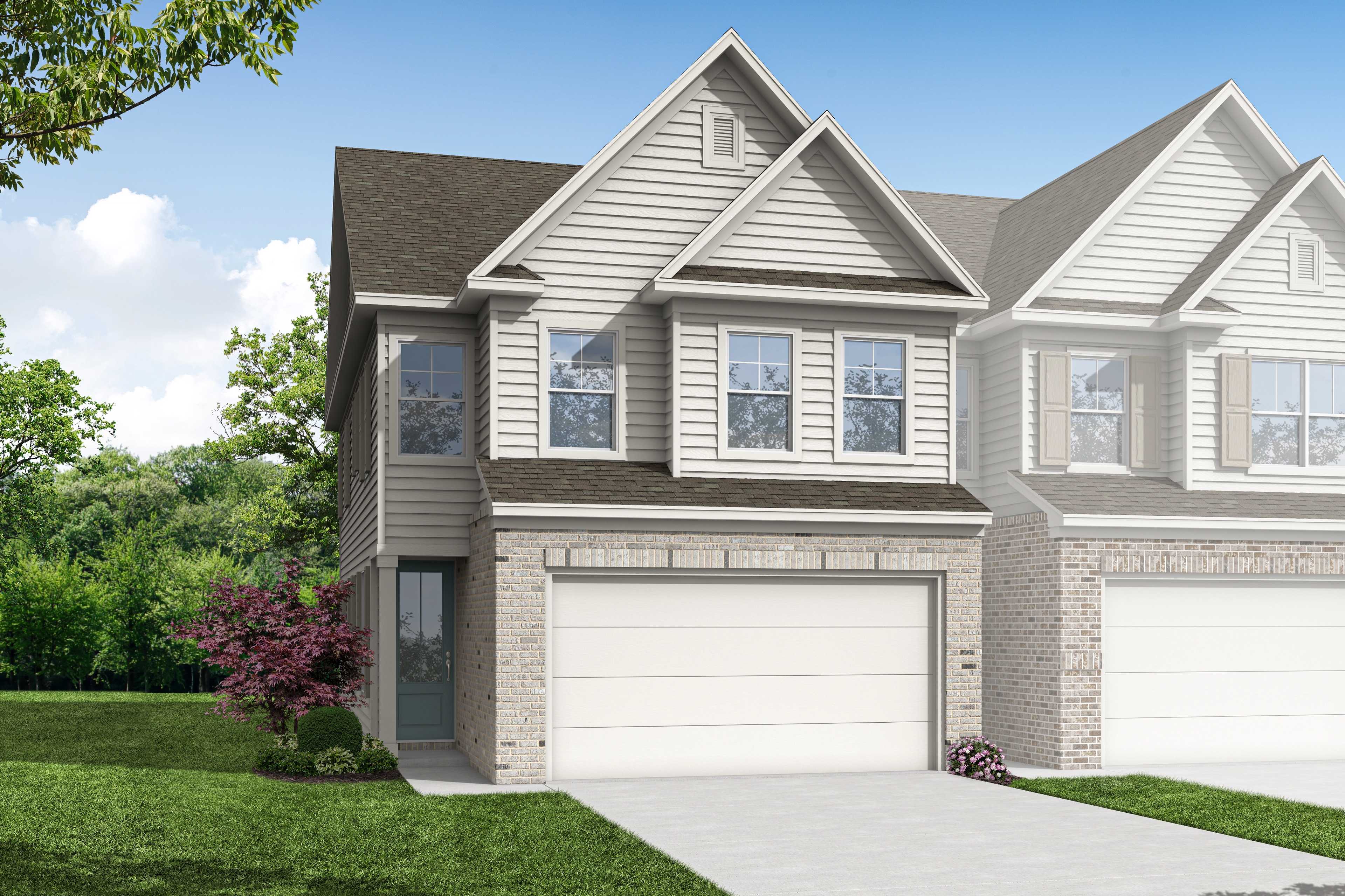 Two-story multi-family home elevation of The Chatham B with gray siding, brick accents, dual two-car garages, and lush landscaping