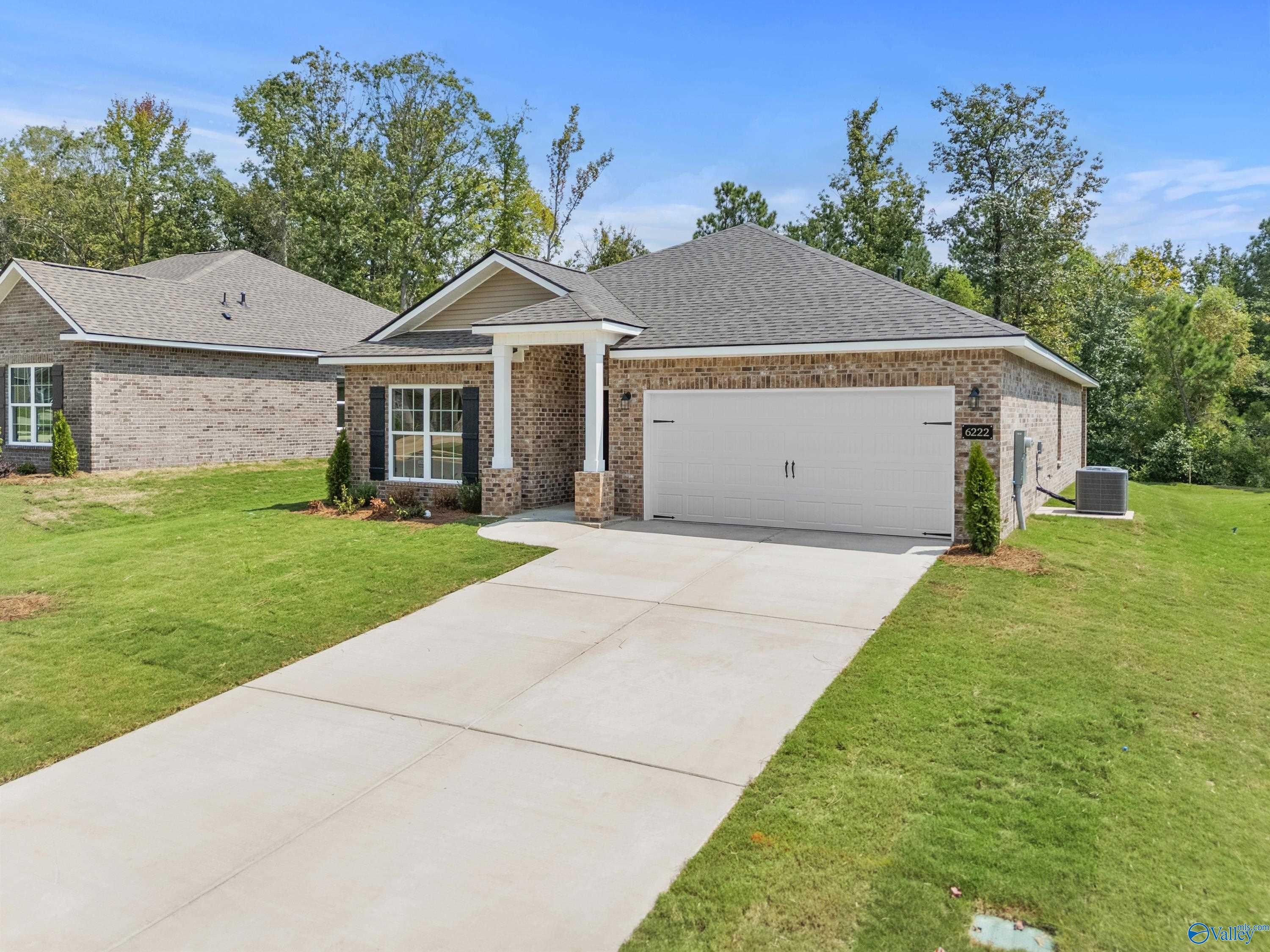 Brick single-story 4-bedroom home with 2-car garage, covered porch, and landscaped yard in Spragins Cove, Huntsville, Alabama by Davidson Homes The Daphne