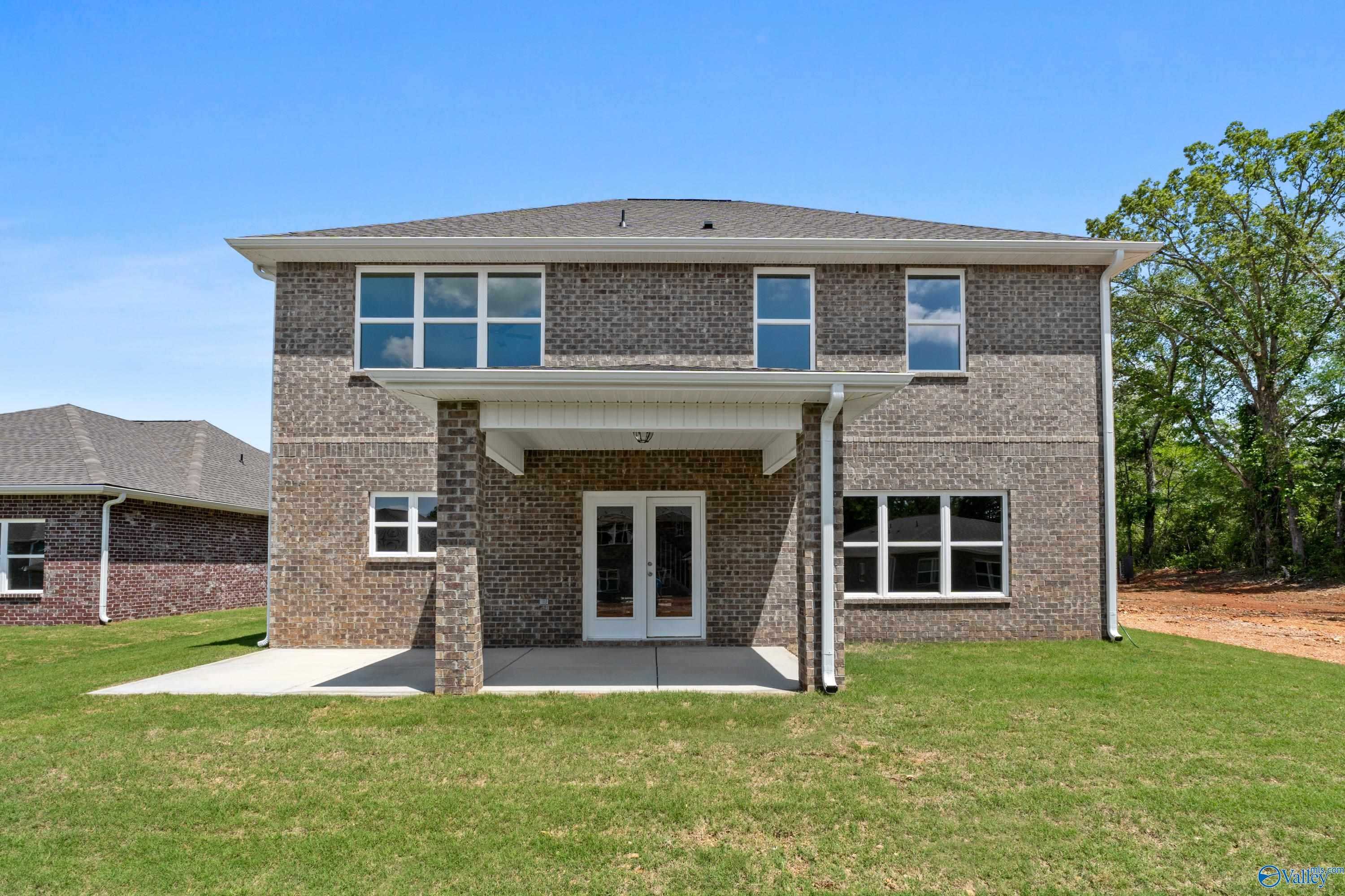 Two-story brick home with covered back patio, double doors, and large windows in Creek Grove, New Market, Alabama - Davidson Homes Chelsea B