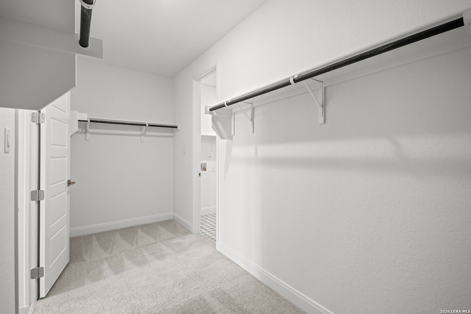 Spacious walk-in closet with shelving in The Lanier G floor plan at The Reserve at Potranco Oaks, Castroville, Texas.