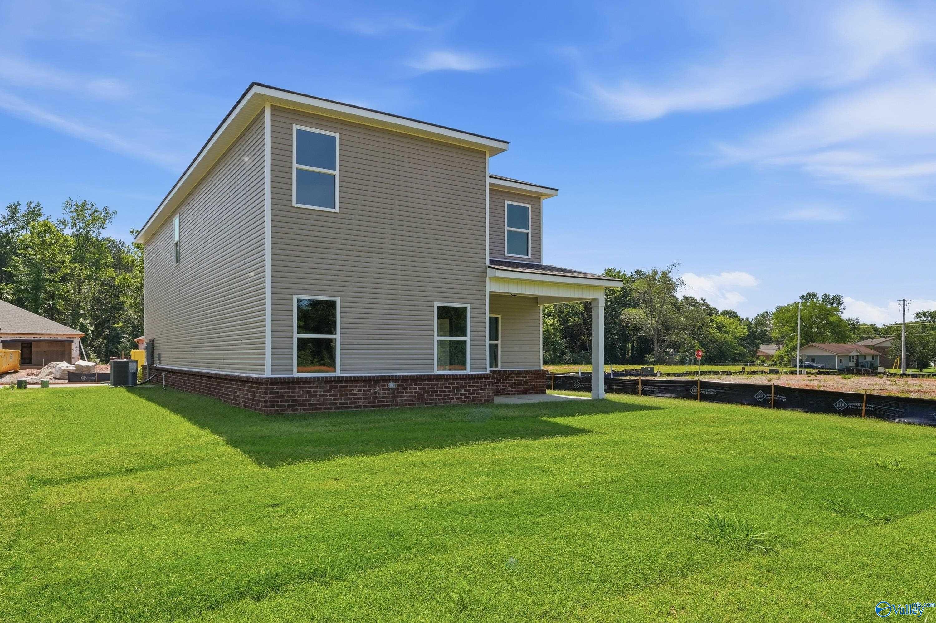 Exterior view of The Russell A floor plan by Davidson Homes featuring a spacious backyard in Spragins Cove, Huntsville, AL.