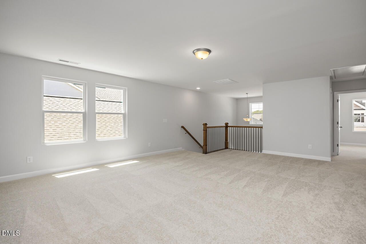 Spacious carpeted loft area in The Adalynn A floor plan by Davidson Homes at Gregory Village in Lillington, NC.