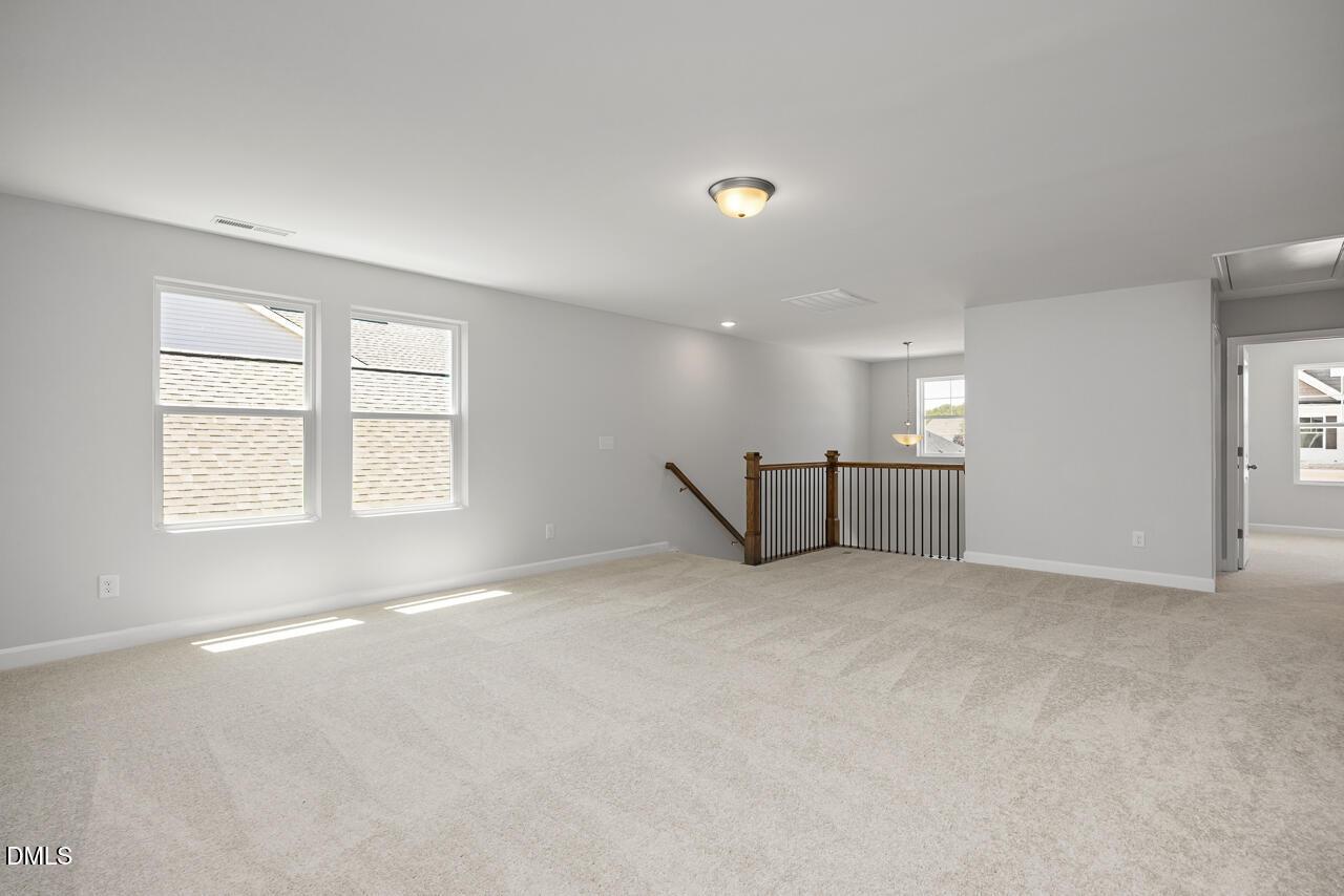 Spacious carpeted loft area in The Adalynn A floor plan by Davidson Homes at Gregory Village in Lillington, NC.