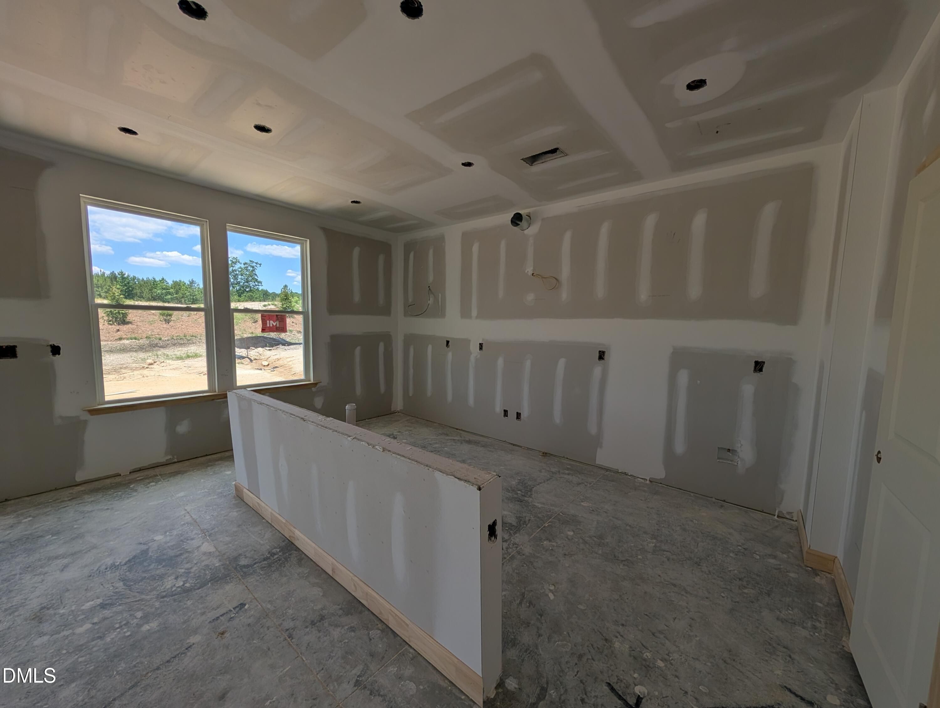 Unfinished kitchen area with drywall in The Chestnut floor plan at Wendell Ridge, Wendell, North Carolina.
