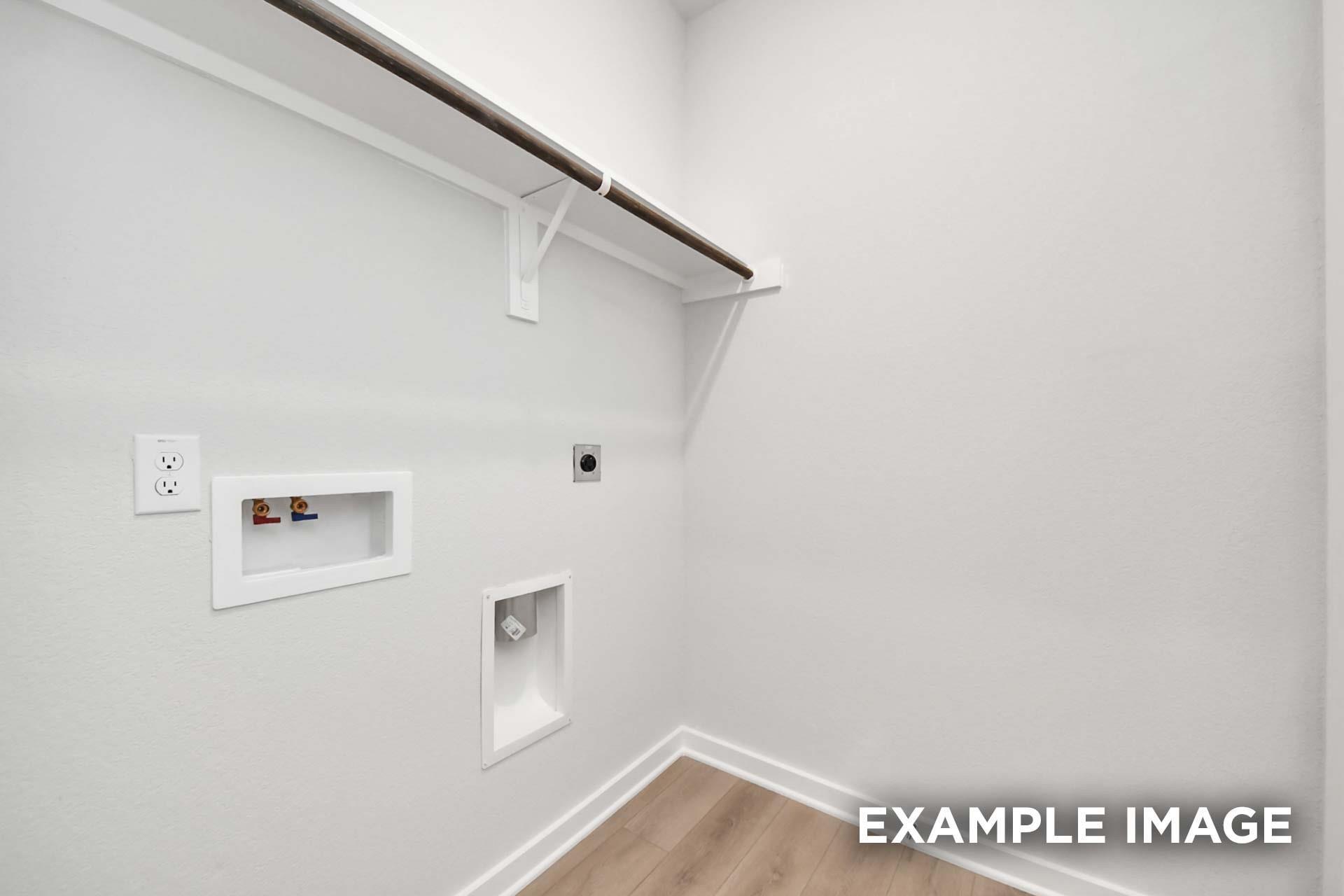 Utility room with washer hookups, electrical outlets, and hanging rod shelving in The Blanco E floor plan, Windmill Estates, Magnolia, Texas