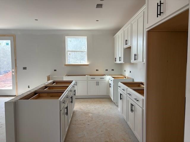 Spacious kitchen with white shaker cabinets and island under construction in The Hickory B home, Davidson Homes, Winder GA