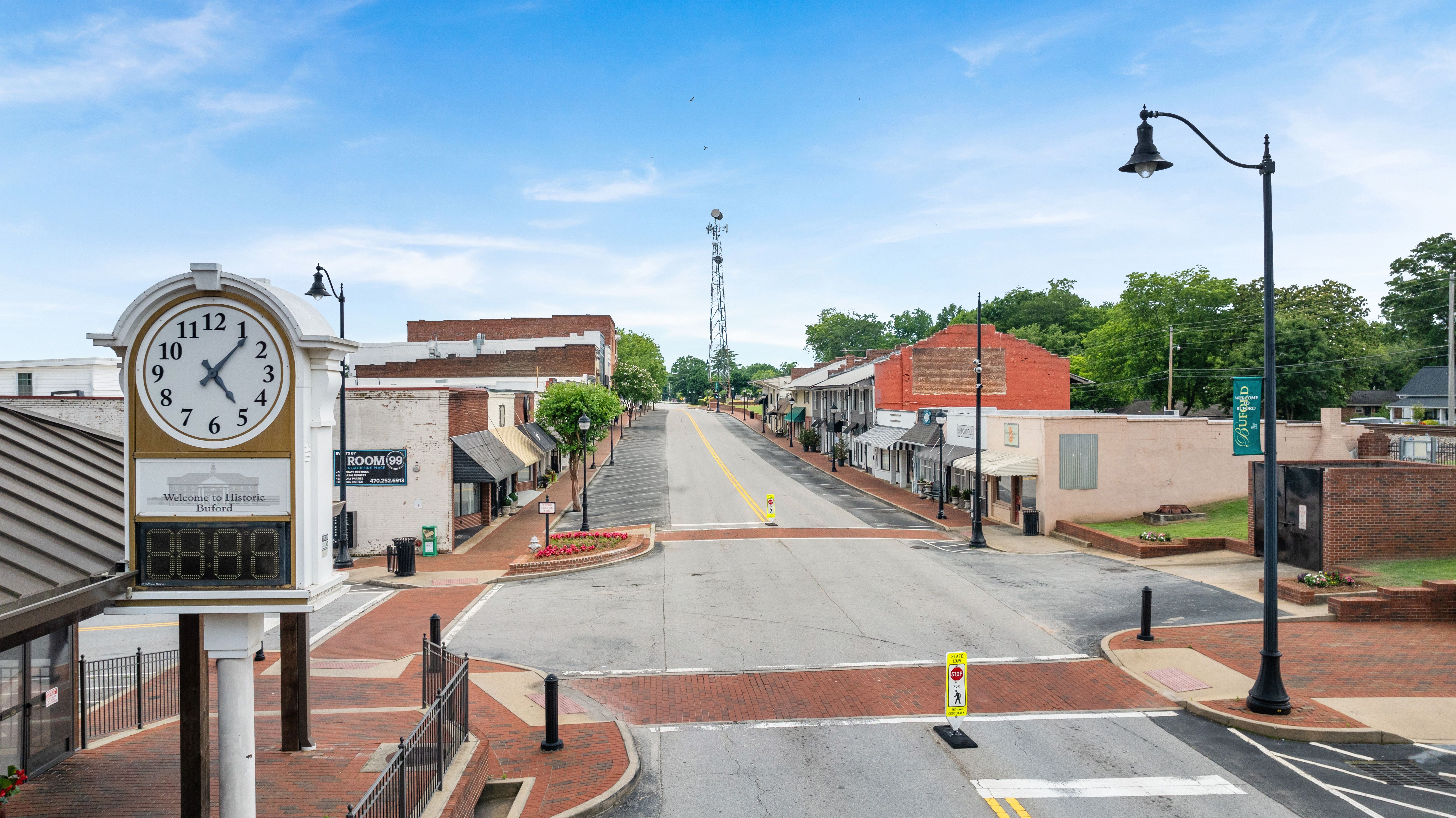 Historic downtown Buford, Georgia street view with landmark clock tower near Melody Lakeside Estates by Davidson Homes.