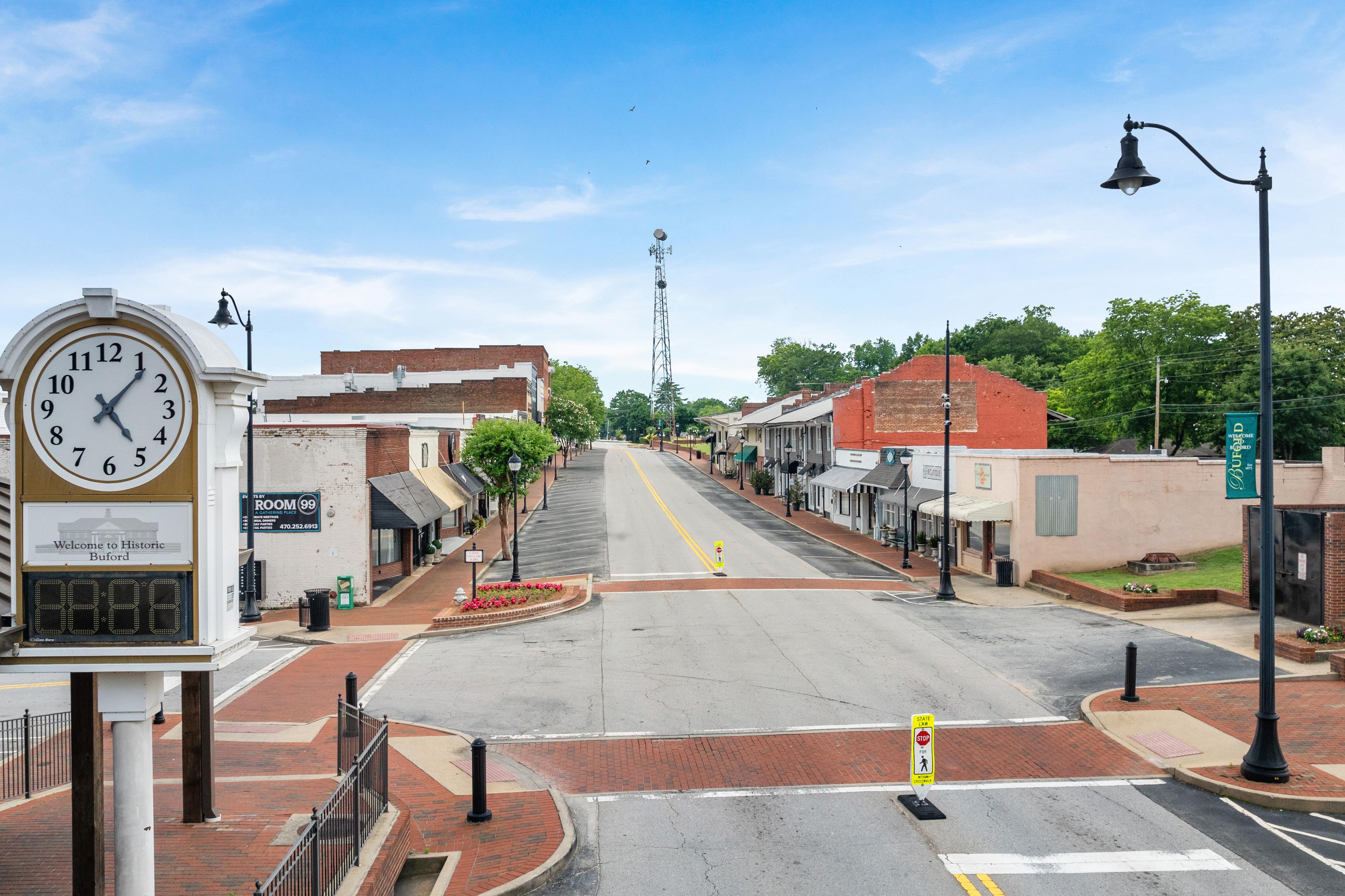 Historic downtown Buford, Georgia street view with landmark clock tower near Melody Lakeside Estates by Davidson Homes.