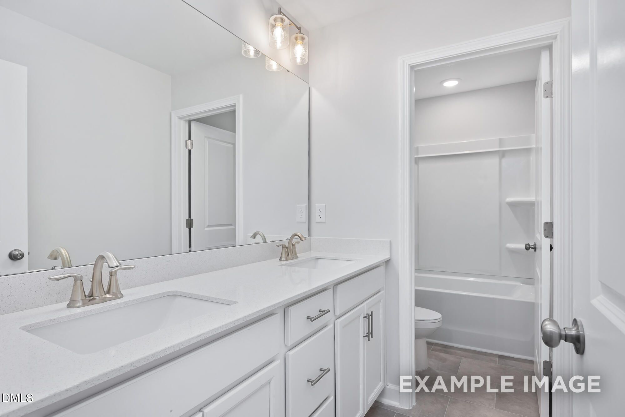 Elegant white double-sink vanity bathroom with soaking tub and walk-in shower in 5-bedroom Hickory II B home, Lillington, NC