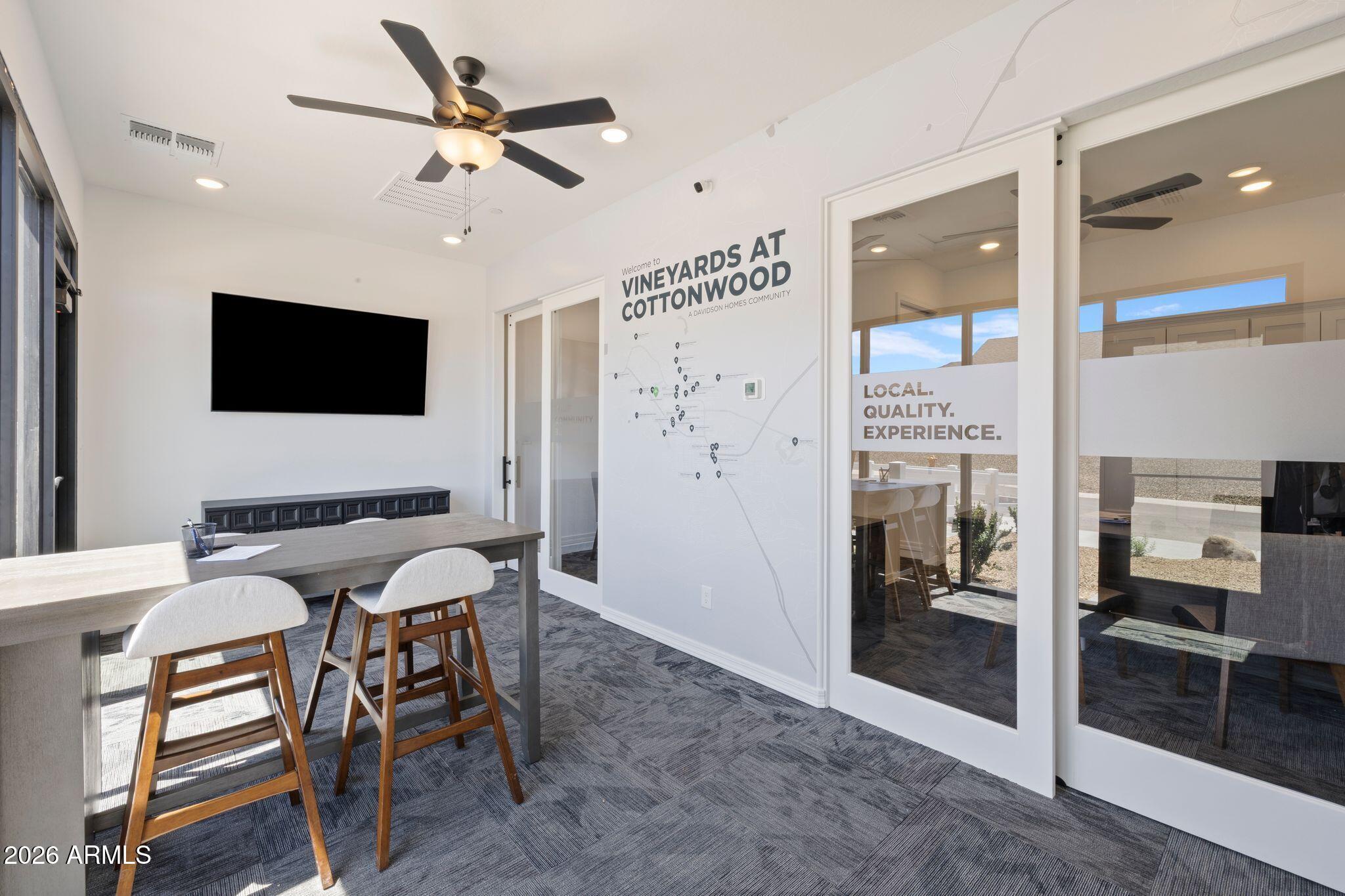 Modern sales office at Vineyards at Cottonwood, featuring a community map and seating area by Davidson Homes.