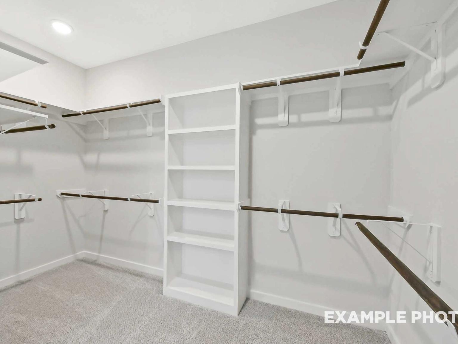 Walk-in closet with built-in shelving and rods in the Sequoia C floor plan by Davidson Homes in Sundance Cove, Crosby.