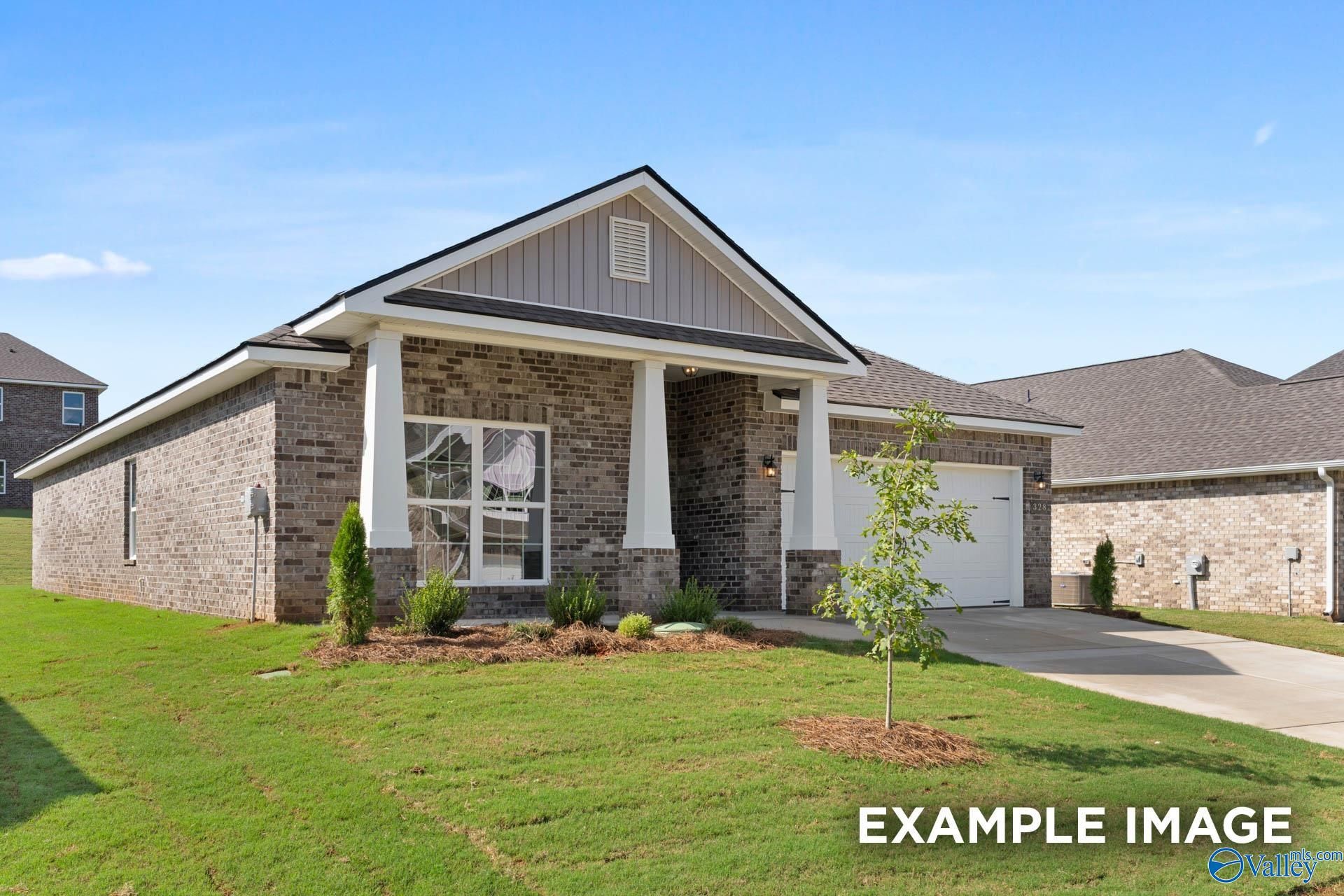 Modern 1-story brick ranch home with covered front porch, columns, large windows, and 2-car garage in Walker's Hill, Meridianville, Alabama