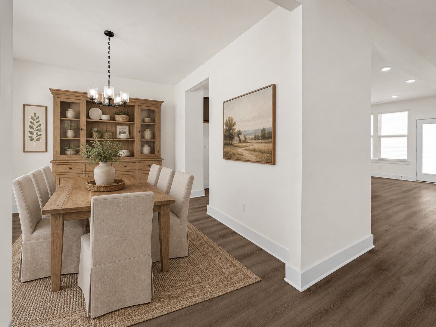Formal dining room with wood table, hutch, and upholstered chairs in The Willow floor plan at Woods Crossing, Gallatin.