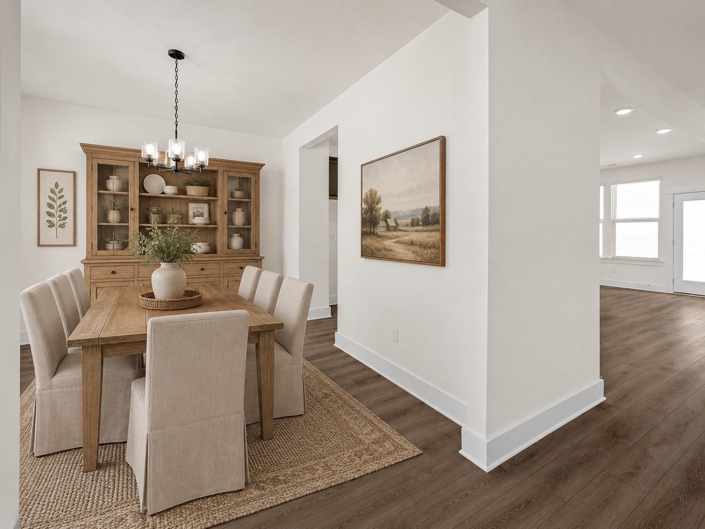 Formal dining room with wood table, hutch, and upholstered chairs in The Willow floor plan at Woods Crossing, Gallatin.