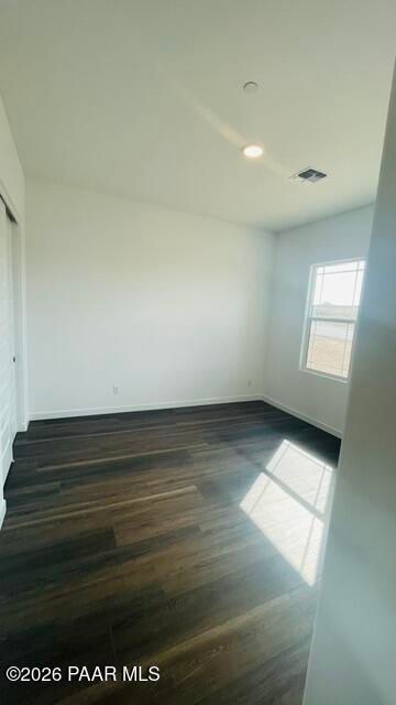 Bright bedroom with dark wood-style flooring in The Aurea C floor plan by Davidson Homes in Hidden Hills, Prescott, AZ.
