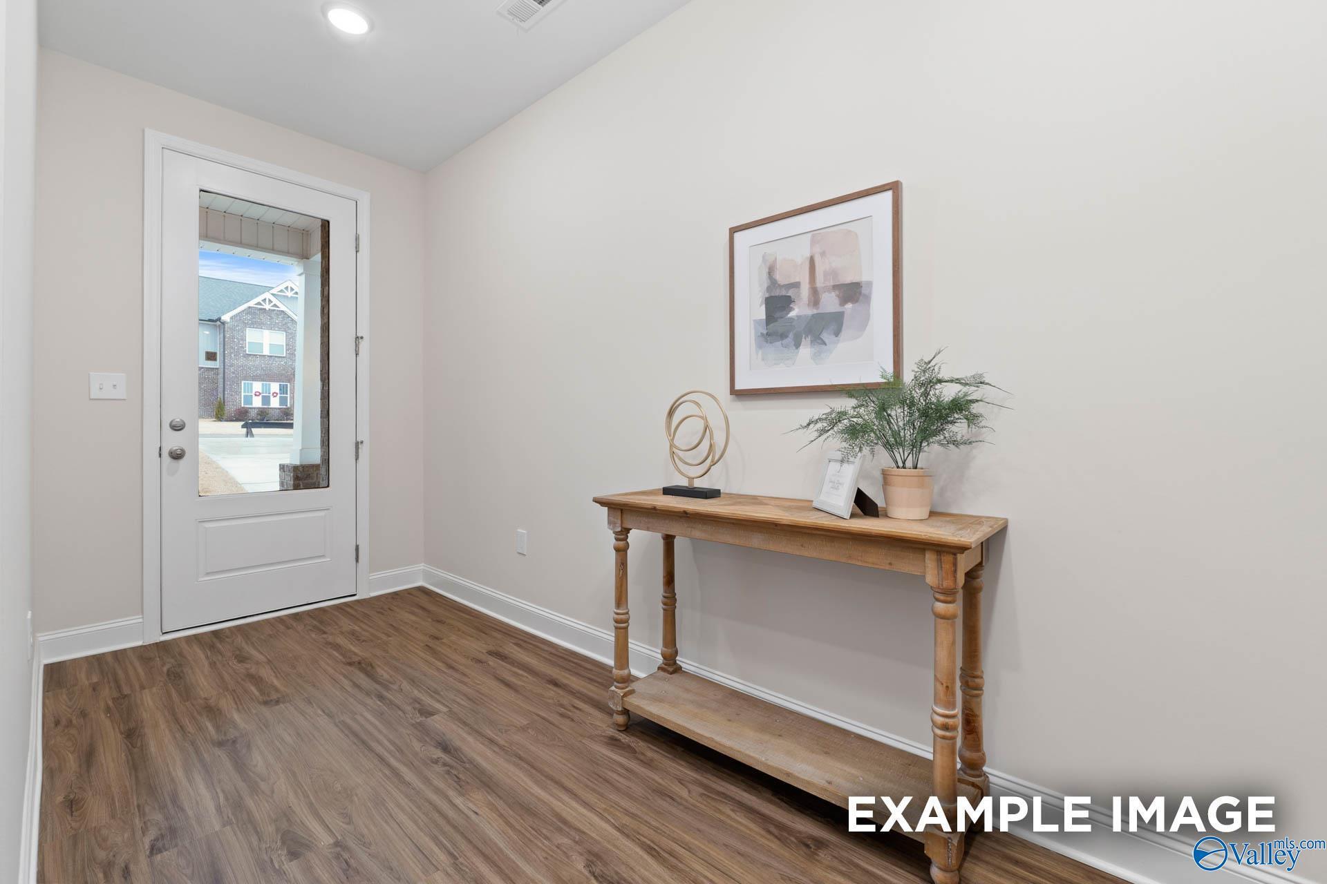 Bright entryway with wood-look flooring and console table in The Daphne D floor plan by Davidson Homes, Huntsville, Alabama.