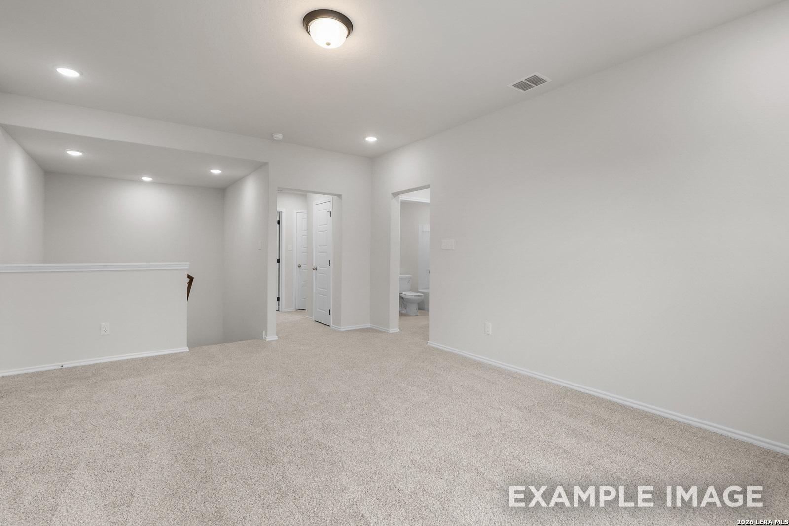 Spacious carpeted upstairs loft in The Sequoia C floor plan by Davidson Homes in Royal Crest, San Antonio, Texas.