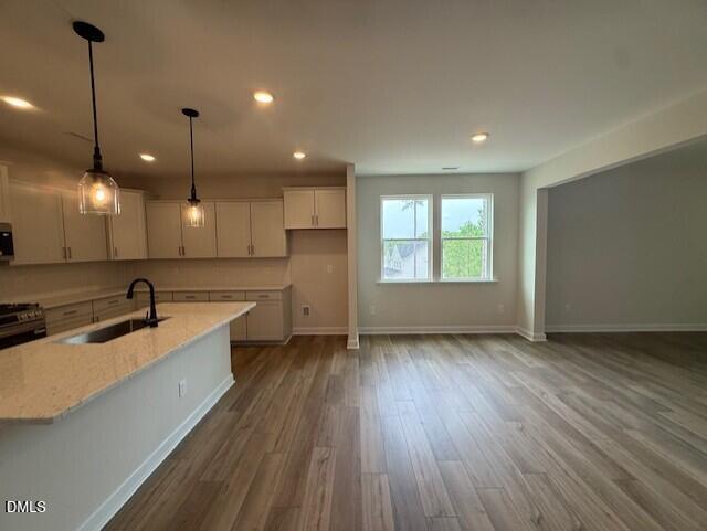 Open-concept kitchen with island and pendant lighting in The Birch II A floor plan at Montrose in Aberdeen, North Carolina.