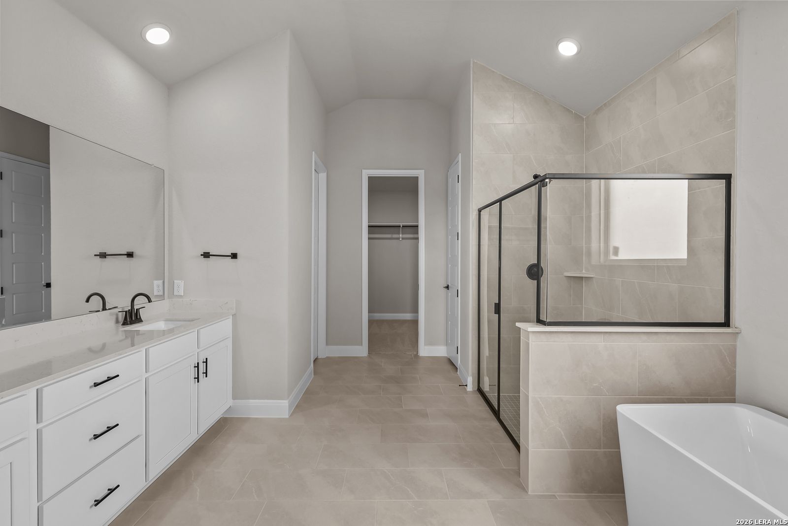 Master bathroom with freestanding tub, walk-in tile shower, and dual vanity in Davidson Homes The Foster E, Castroville, Texas