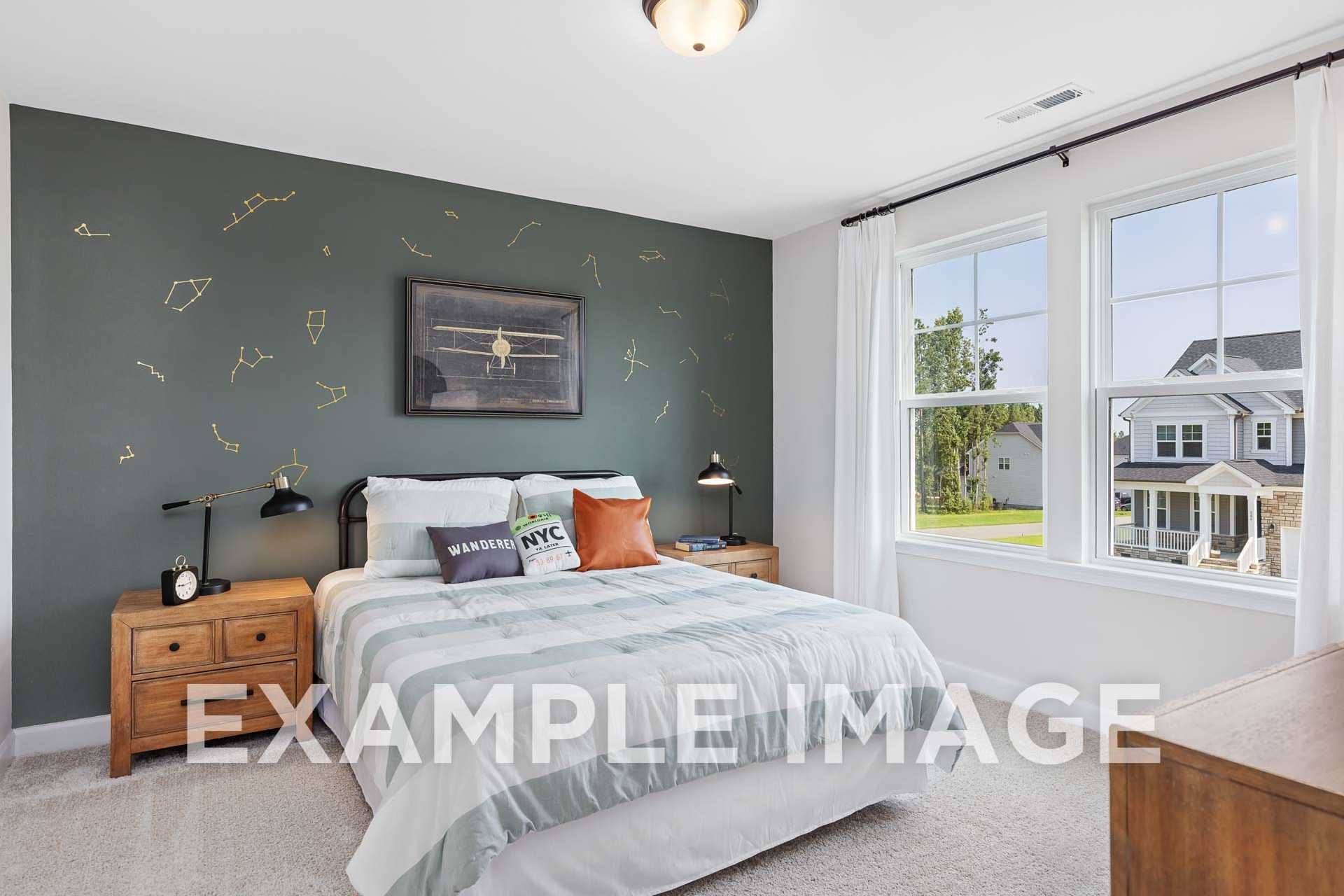 Aviation-themed kids' bedroom in The Willow with green starry accent wall, framed plane art, cozy bed, and Wake Forest neighborhood view