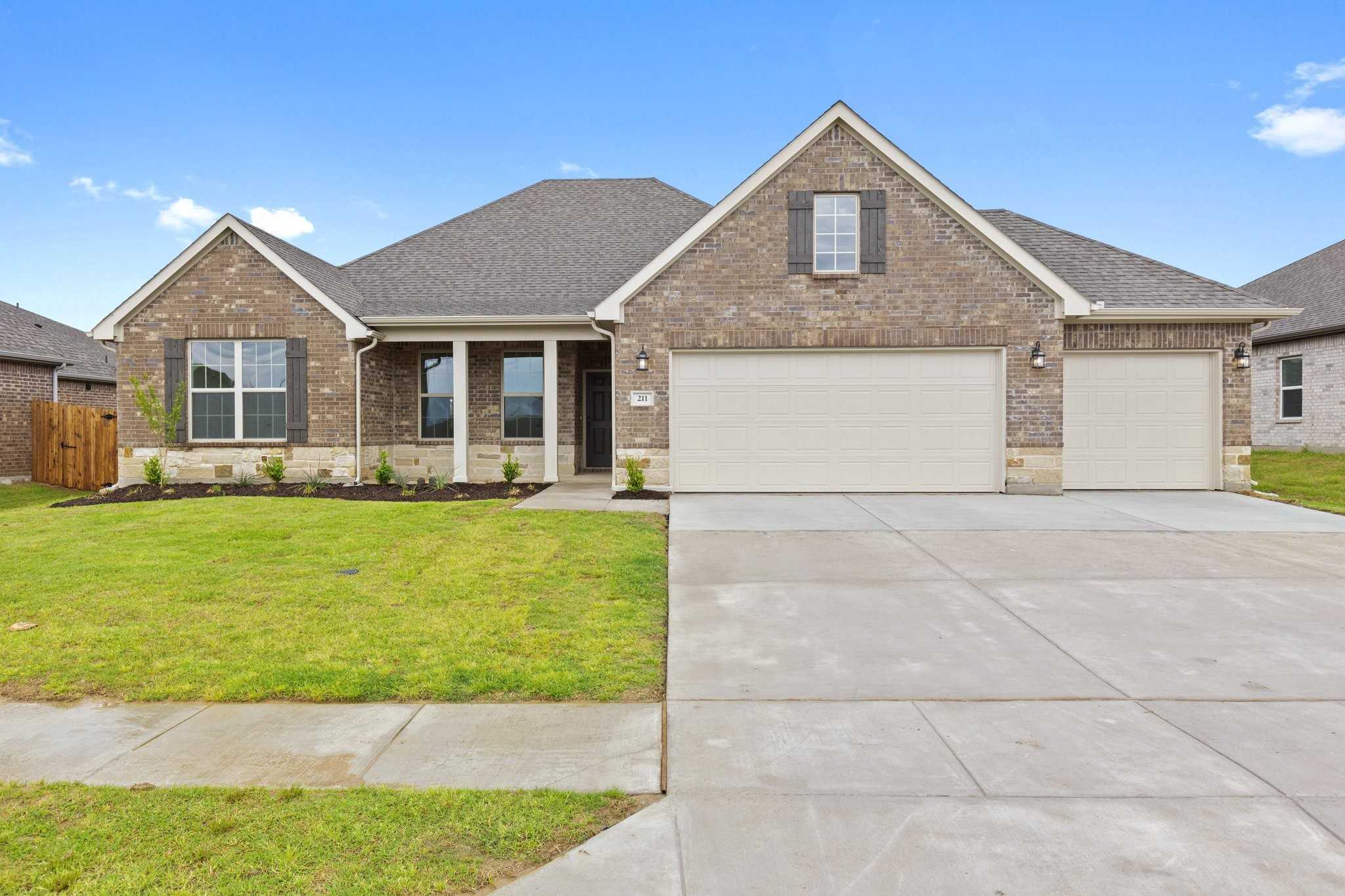 Brick single-story 4-bedroom home with 3-car garage, front porch, and landscaped yard in Waverly Estates, Josephine, Texas by Davidson Homes The Rockford C