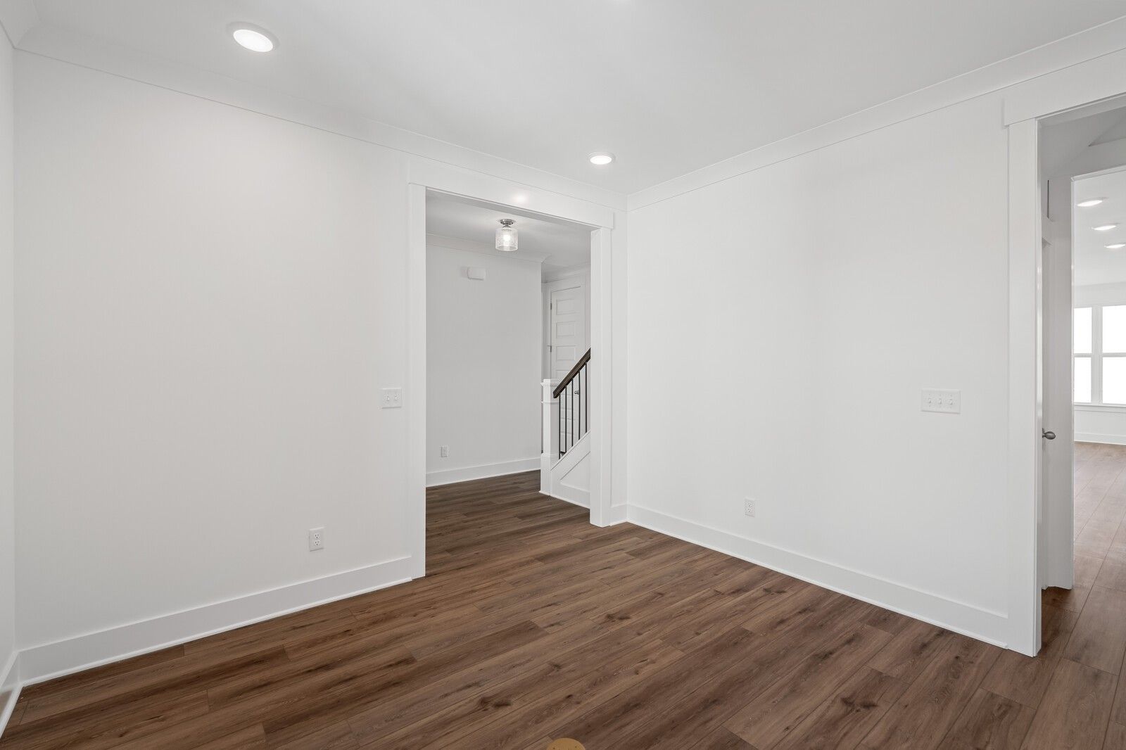 Bright foyer with white walls, recessed lights, hardwood floors and oak staircase in The Hawkins floor plan, Murfreesboro, TN