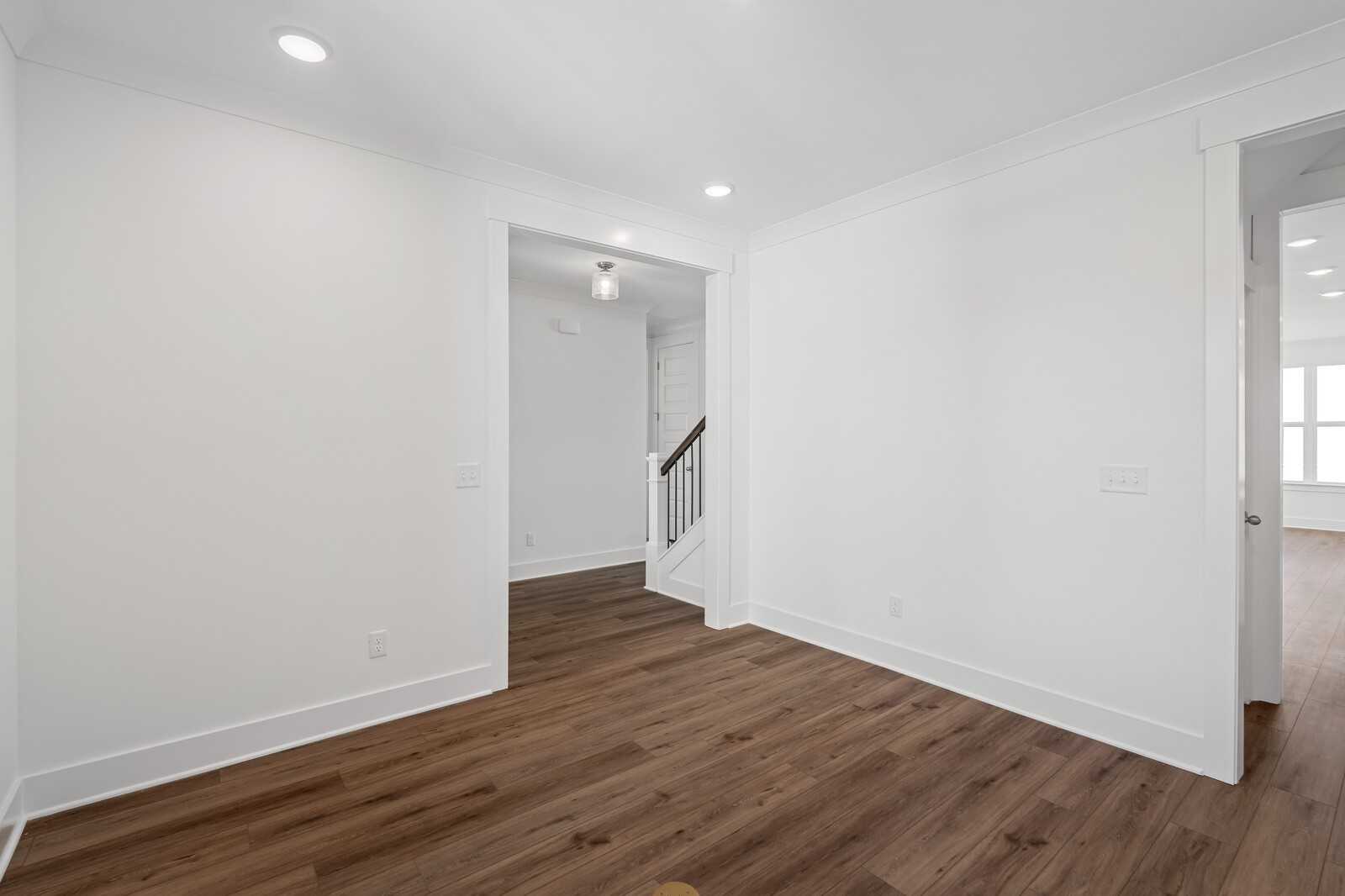 Bright foyer with white walls, recessed lights, hardwood floors and oak staircase in The Hawkins floor plan, Murfreesboro, TN