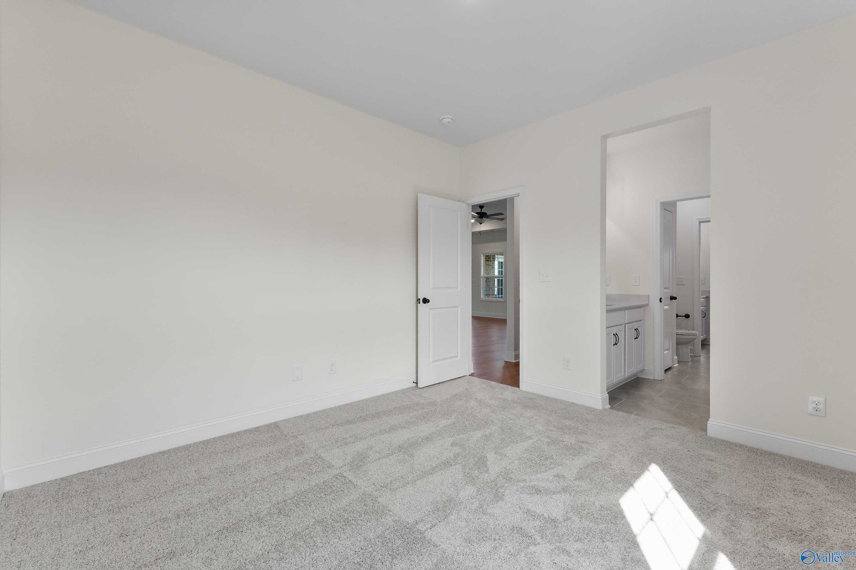 Spacious bedroom with en-suite bathroom featuring double vanity in Davidson Homes The Finleigh, Creekside, Harvest, Alabama