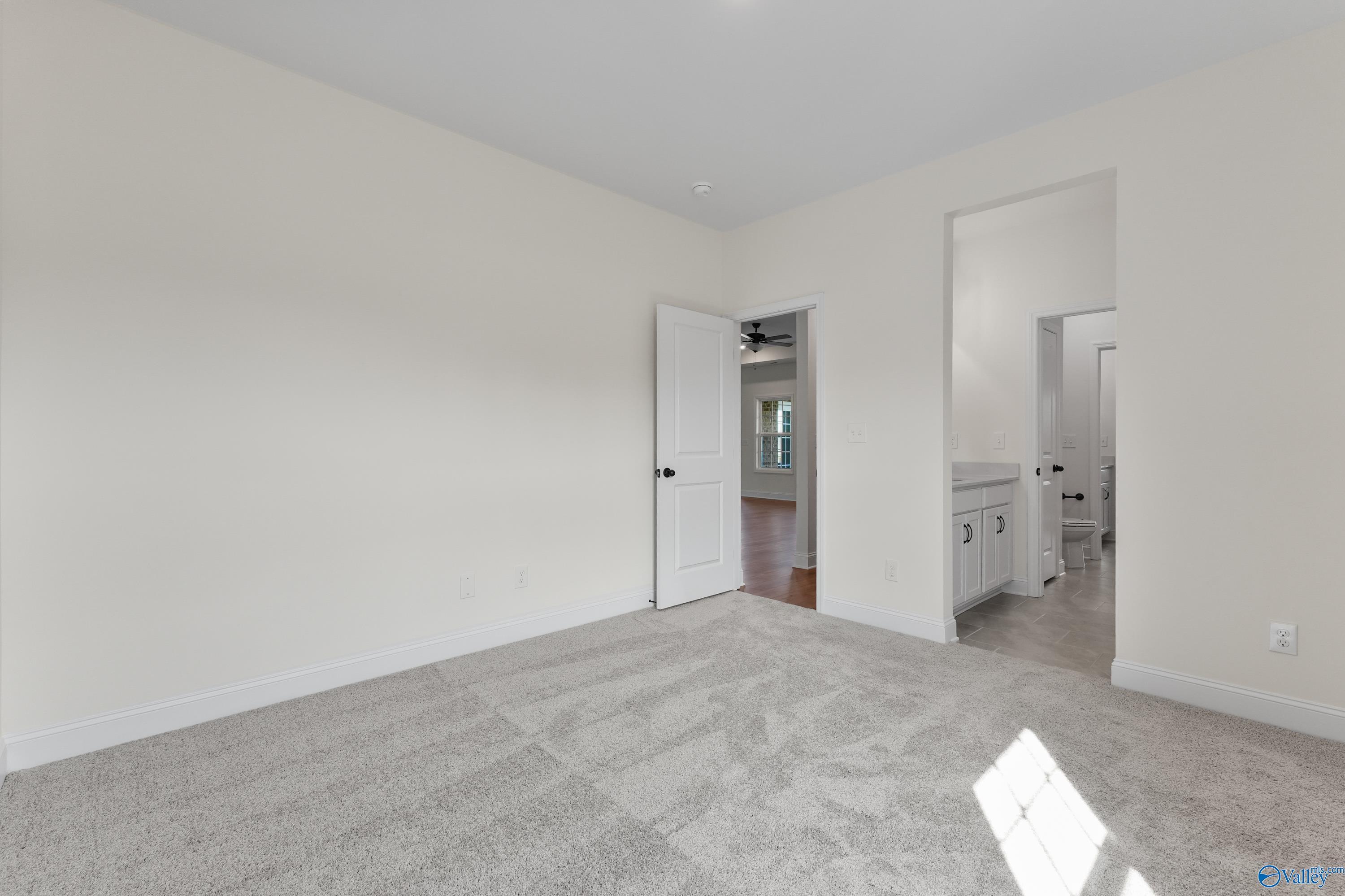 Spacious bedroom with en-suite bathroom featuring double vanity in Davidson Homes The Finleigh, Creekside, Harvest, Alabama