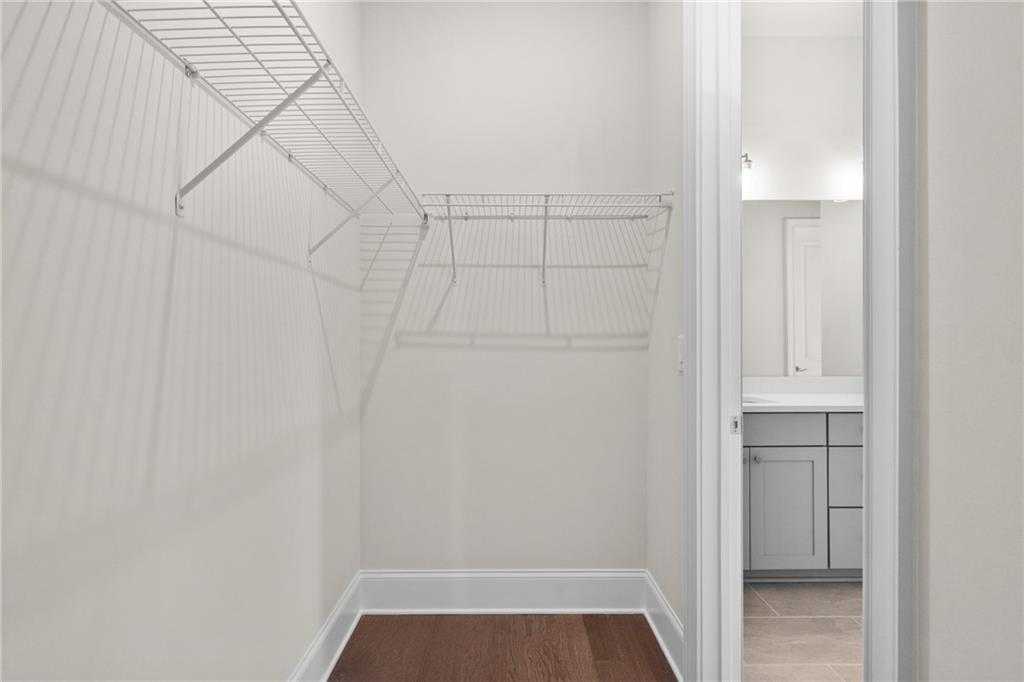 Spacious walk-in closet with wire shelving, hardwood floors, adjacent bathroom in master suite, Davidson Homes The Arlington A, East Cobb