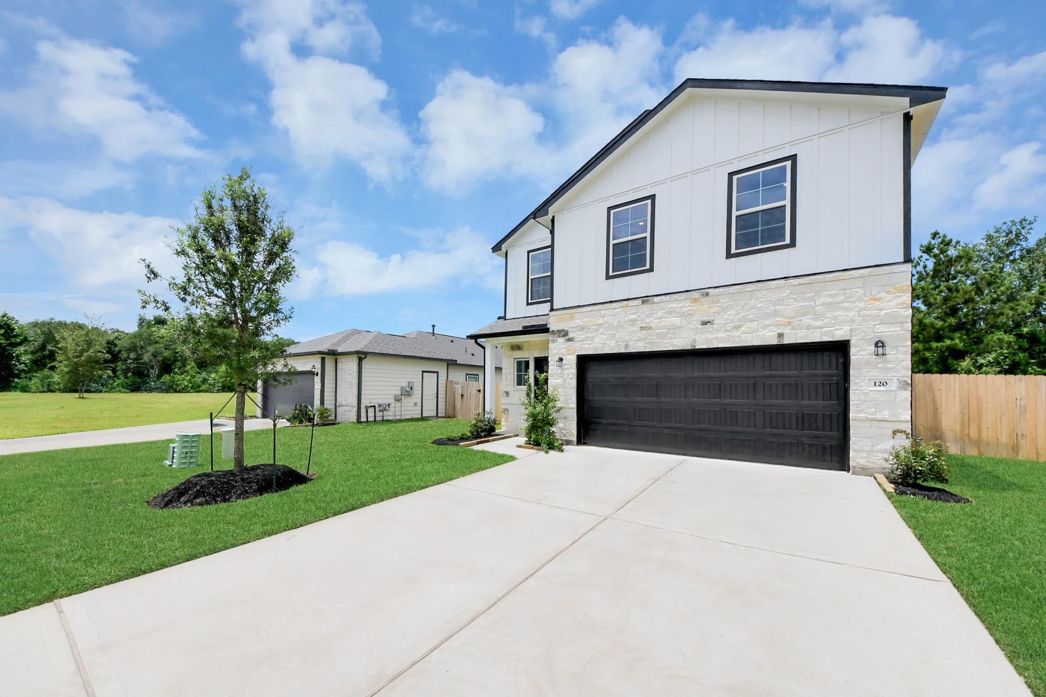 Two-story Blanco E floor plan home with a two-car garage at Caney Creek Place in Conroe, Texas.