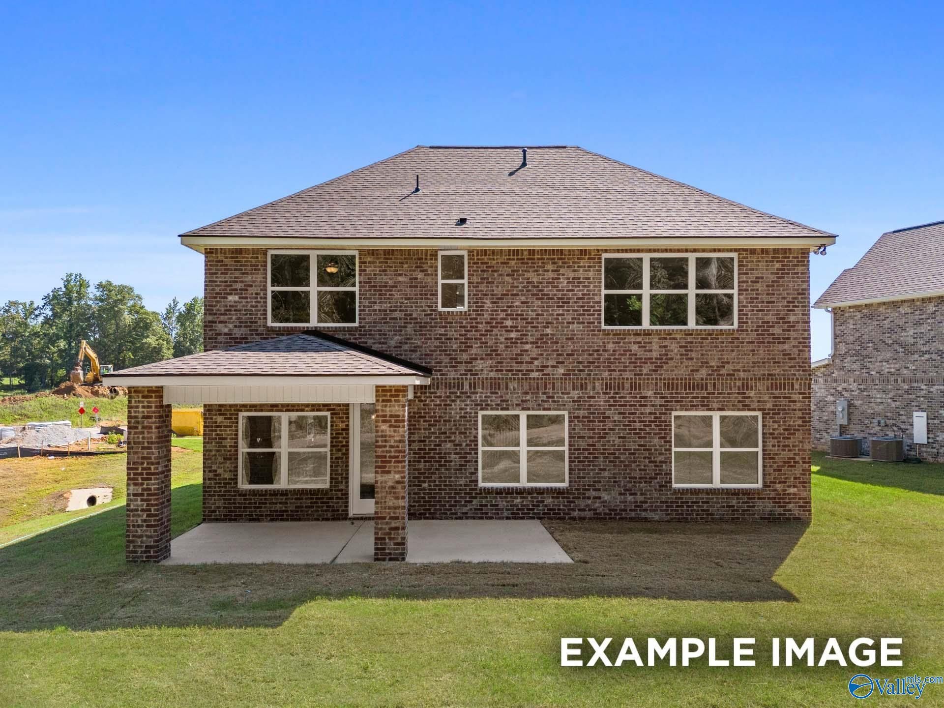 Two-story brick home with covered front porch, large windows, and grassy lot in The Highlands, Arab, Alabama - Davidson Homes The Shelby C