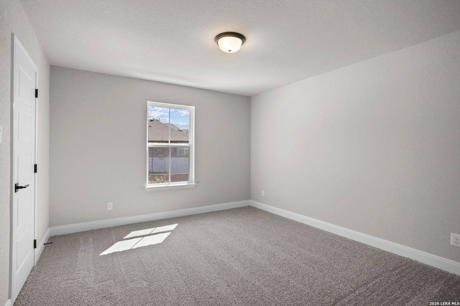 Spacious secondary bedroom with neutral carpet and paint in The Jennings G floor plan at Ladera, San Antonio, Texas.